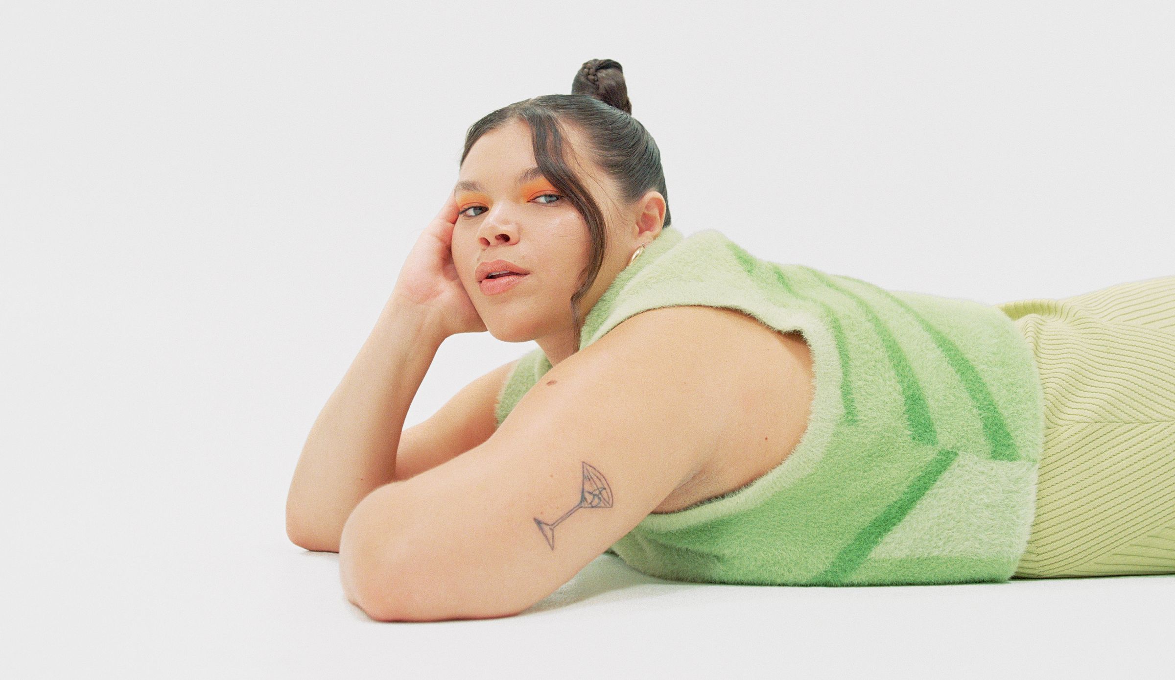 woman with martini glass tattoo on arm