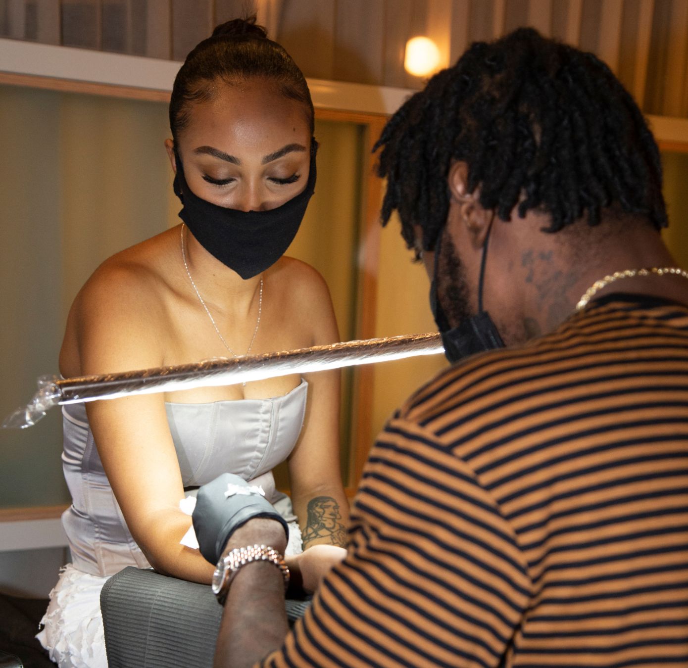 ephemeral temporary tattoo artist applying tattoo with needle