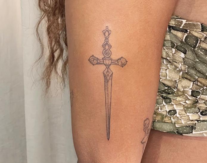 ephemeral temporary tattoo idea of sword design of a woman arm
