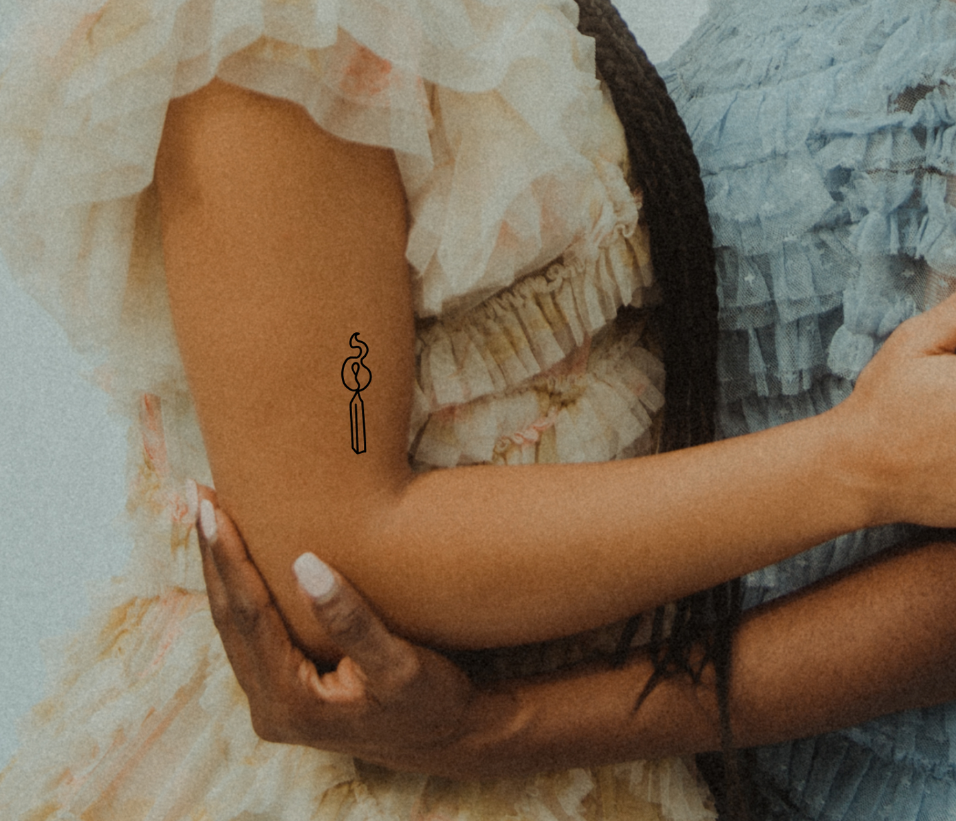 lit match tattoo on arm
