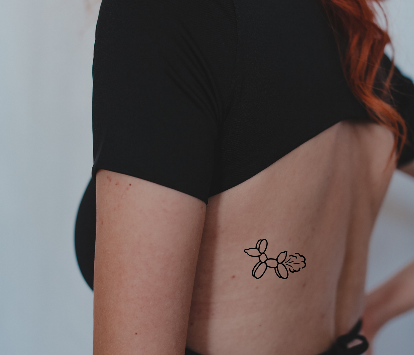 balloon animal tattoo on back