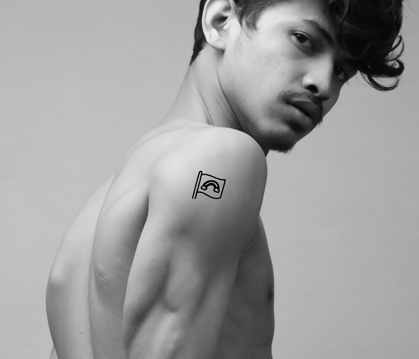 rainbow flag tattoo on arm