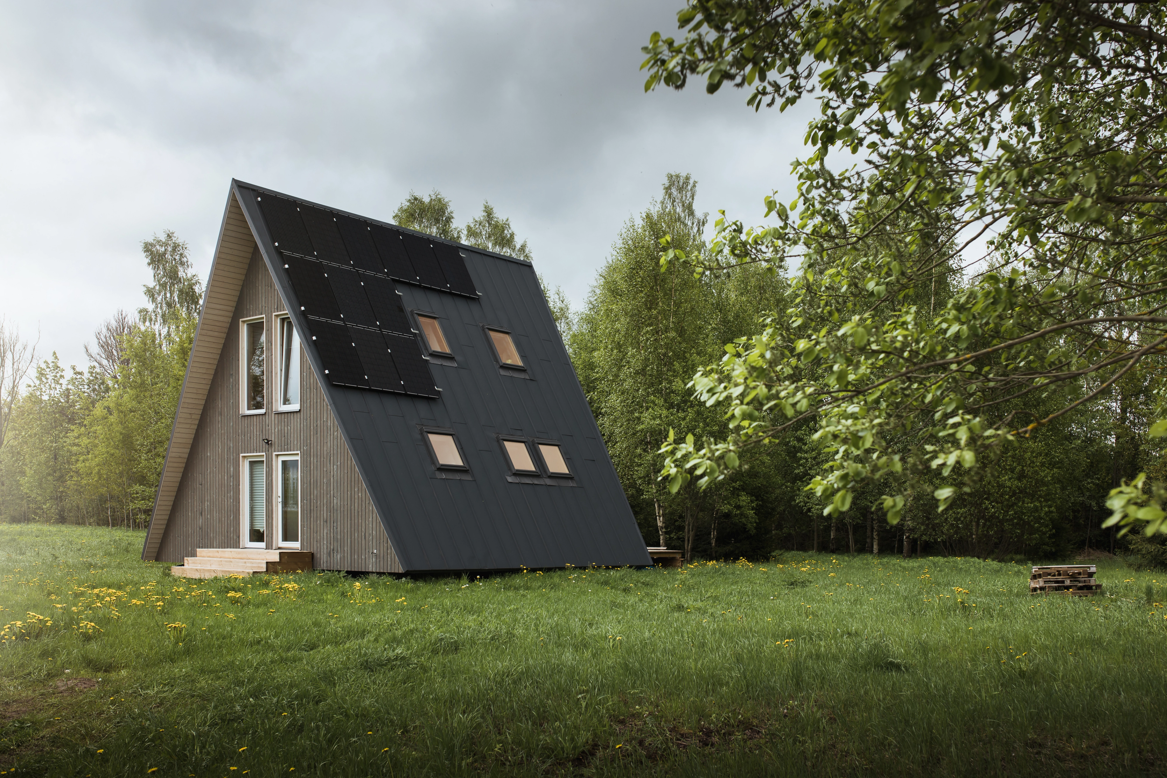 A-frame in the nature with solar panels installed on the roof