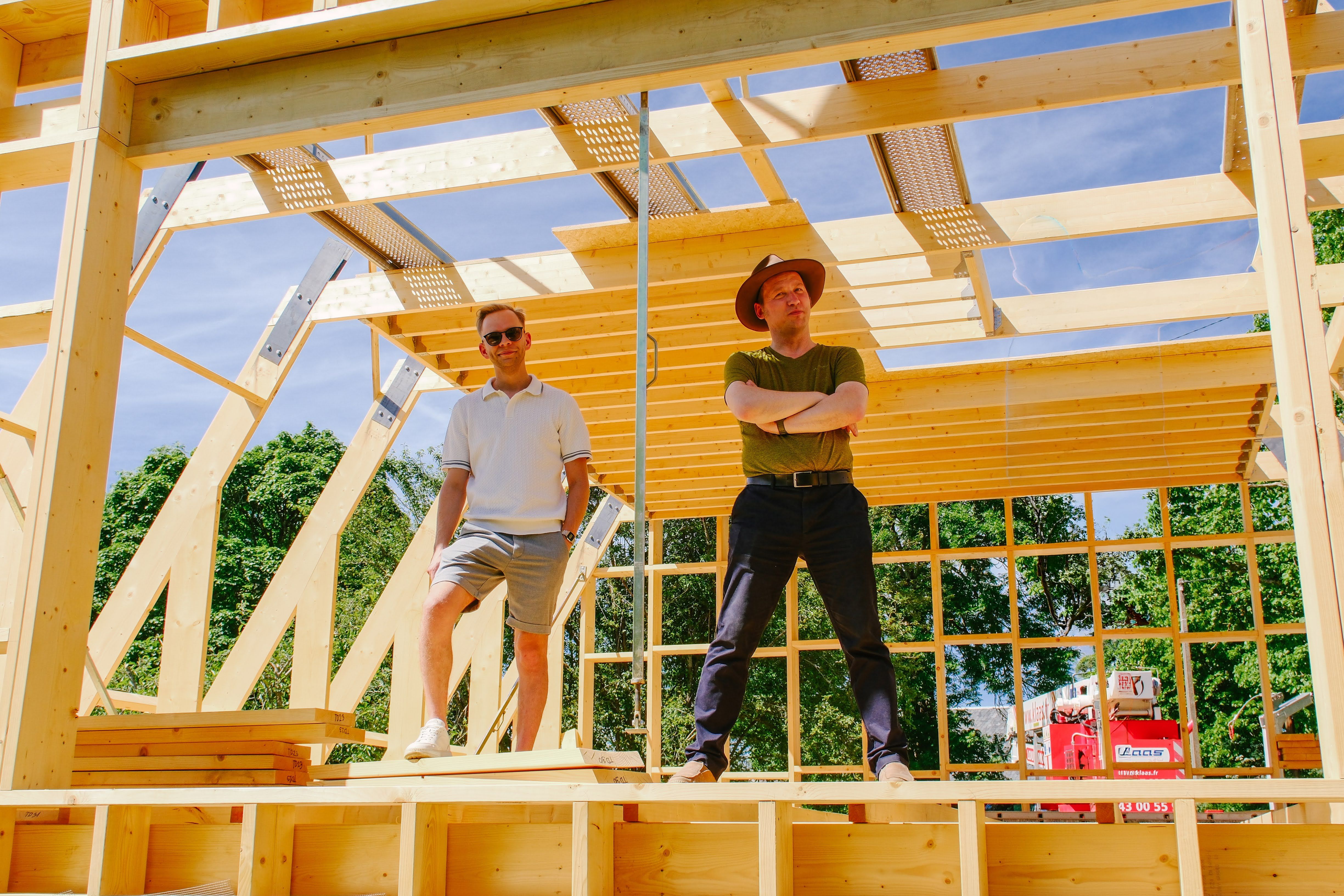Avrame CEO Indrek Kuldkepp and Head of Sales Priit standing inside the timber frame of an A-frame house under assembly in France