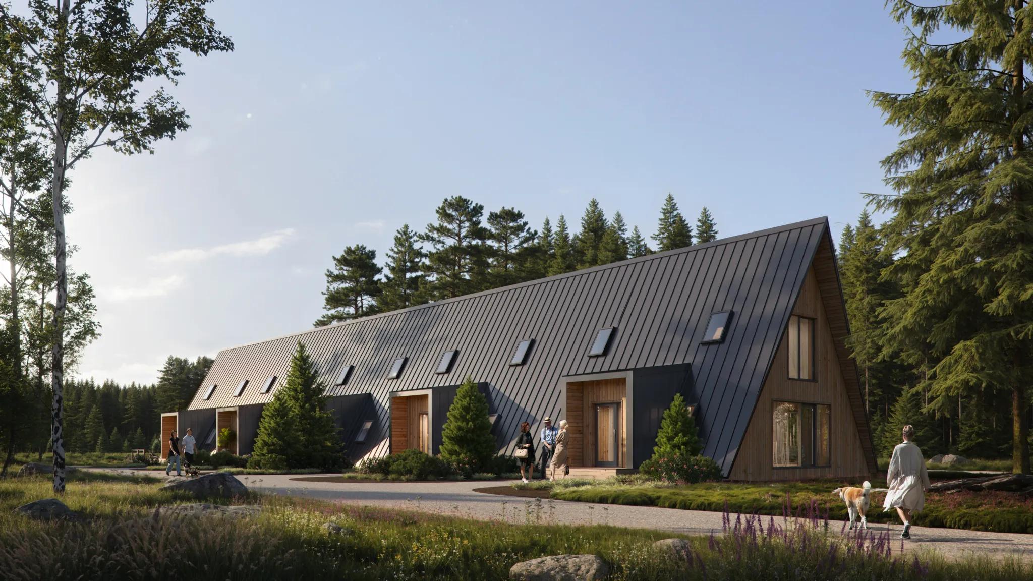 A row of modern A-frame townhouses with dark metal roofing and integrated skylights is shown in a peaceful forest setting with people walking along a winding path.