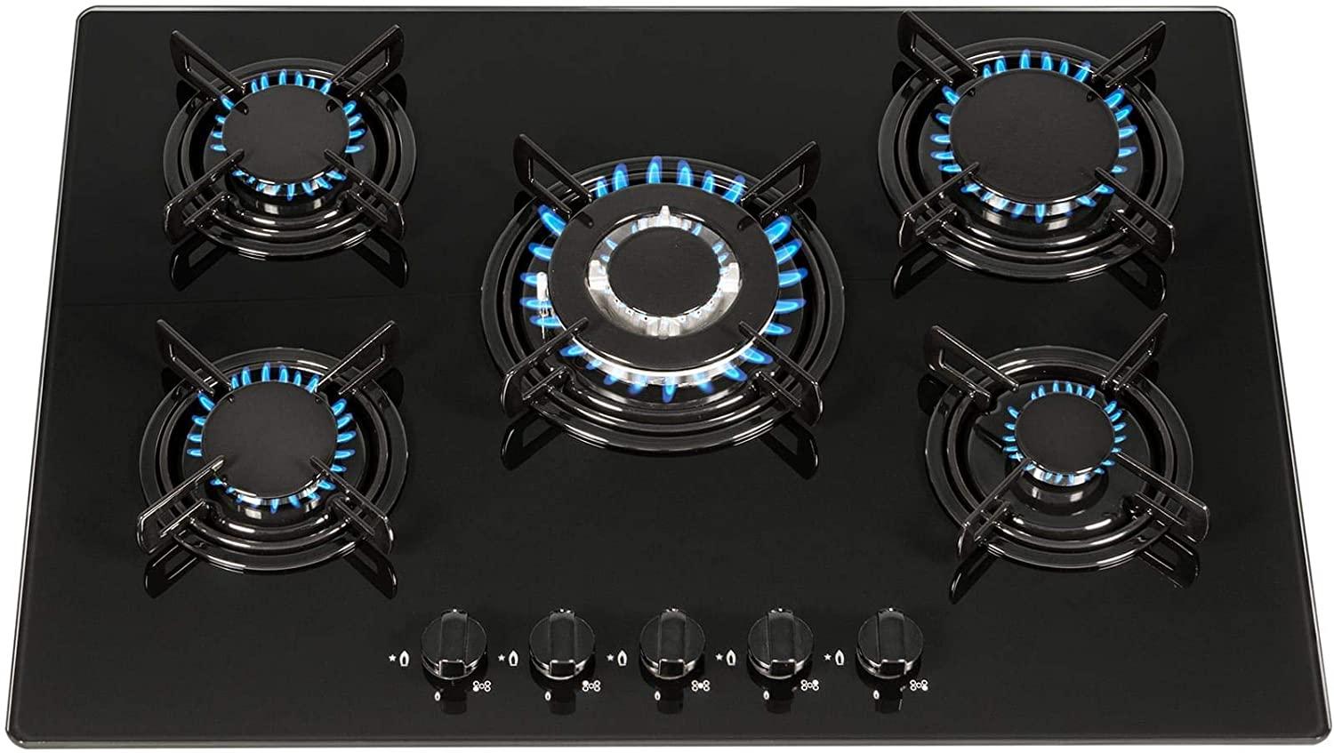 Gemini said A five-burner black glass gas cooktop is shown with all burners lit, displaying steady blue flames and front-mounted control knobs.