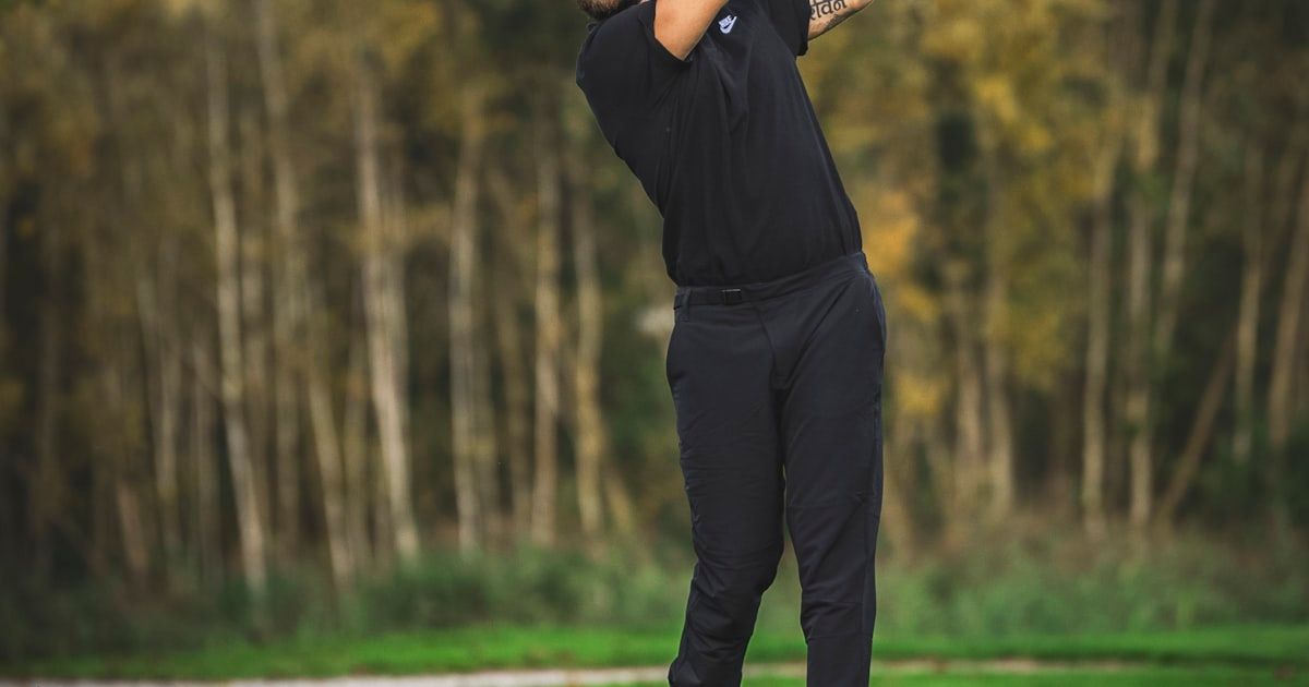 Golfer demonstrating powerful lower body drive and balanced finish in the golf swing