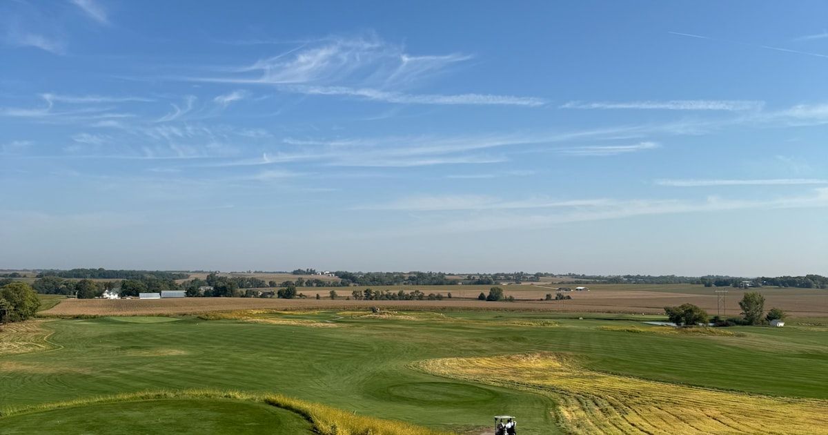 Golf cart on a winding path through lush green fairways