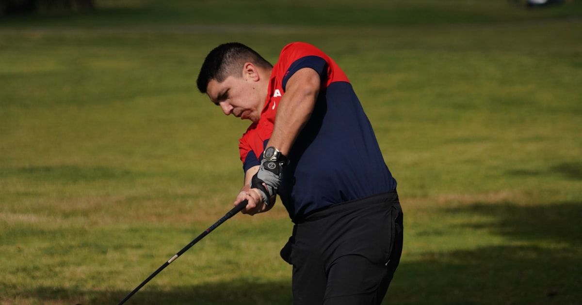 Golfer executing a swing on the course demonstrating trained mechanics