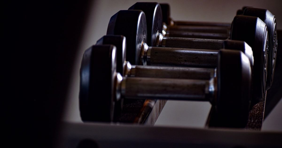 Row of dumbbells in a gym representing common golf fitness misconceptions
