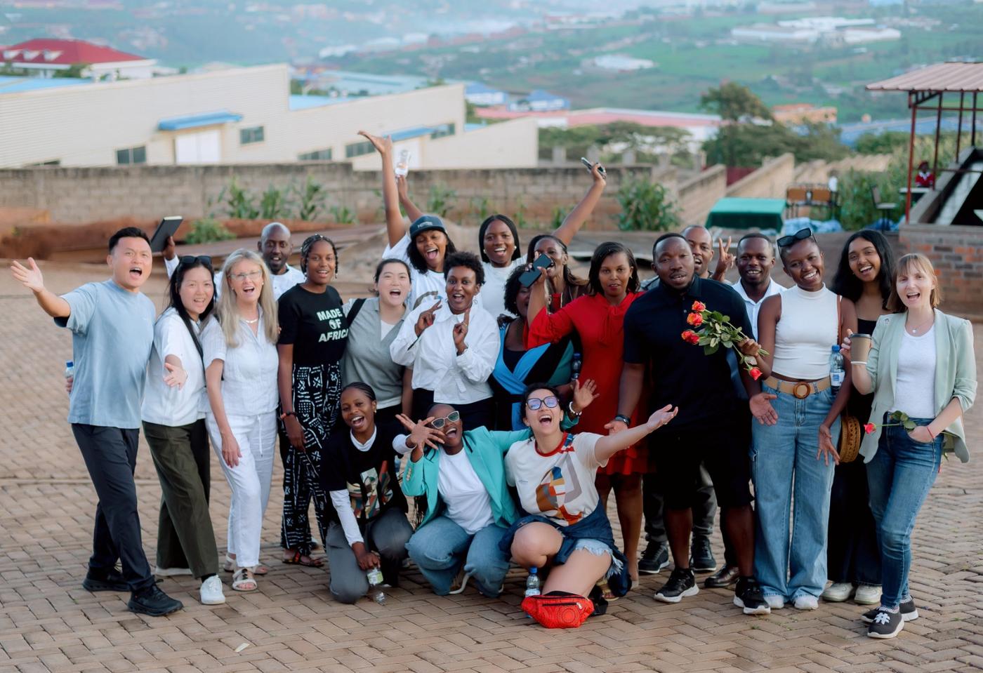The visiting delegation and DIKAM team together at the factory site, with Kigali's hills behind