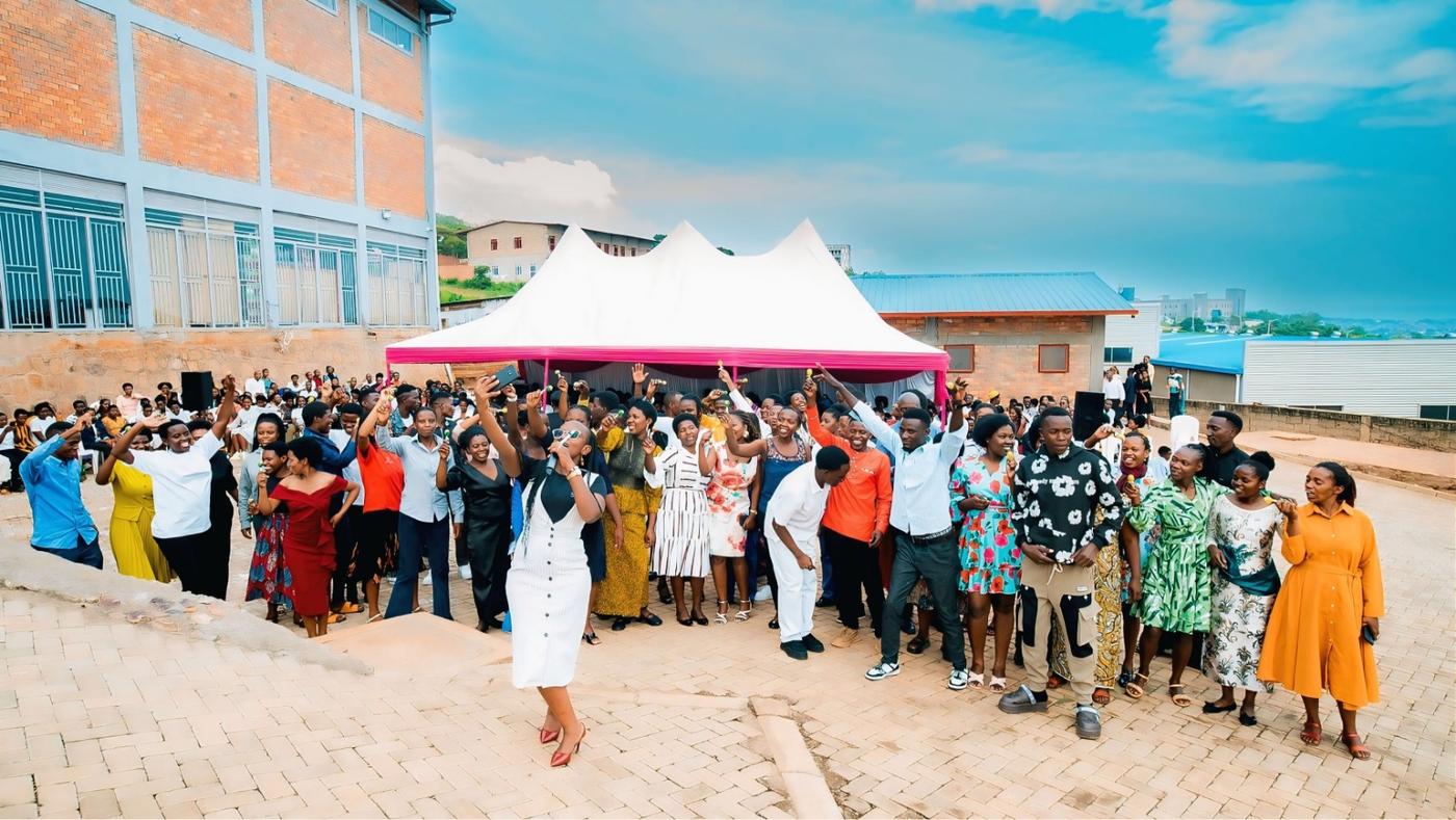 DIKAM staff in their best dress celebrating under a tent in the factory yard