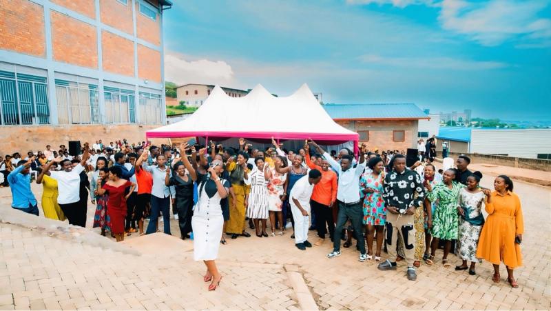 DIKAM staff in their best dress celebrating under a tent in the factory yard