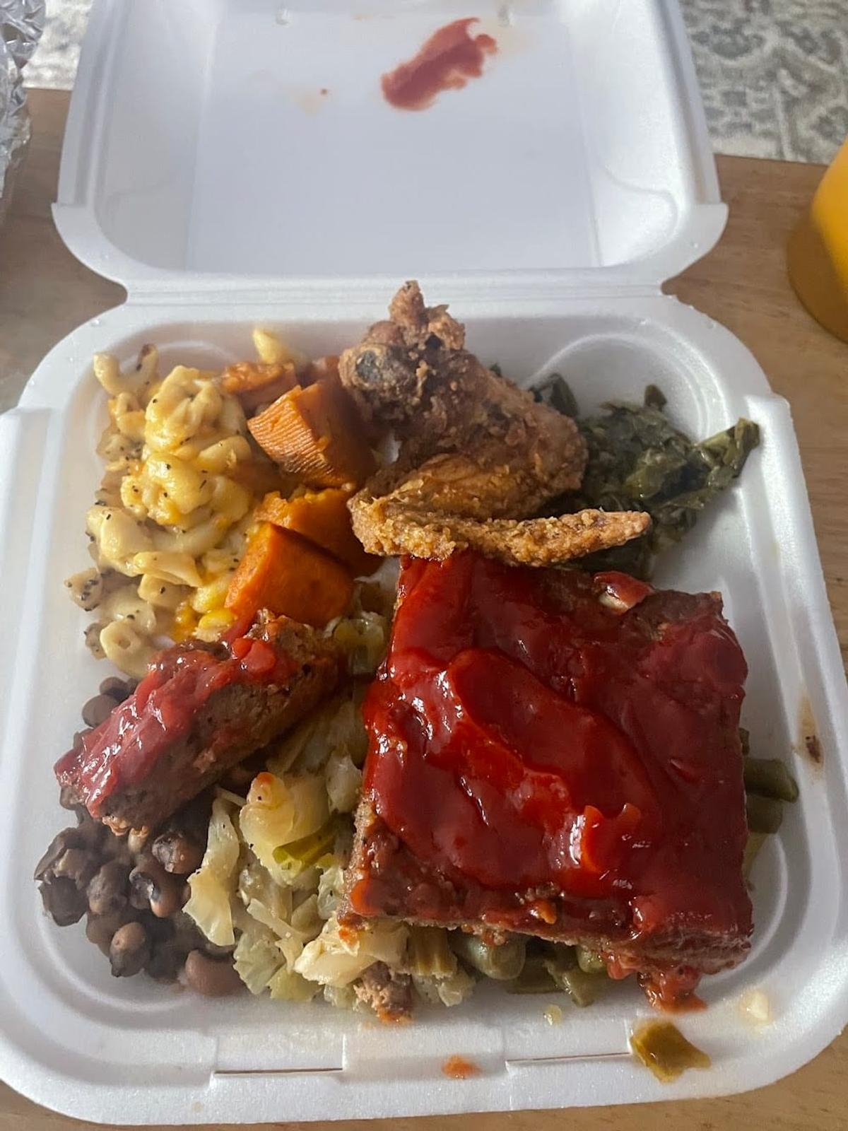 Zion Delight takeout box with BBQ ribs, fried chicken, mac and cheese and collards — Atlanta soul food