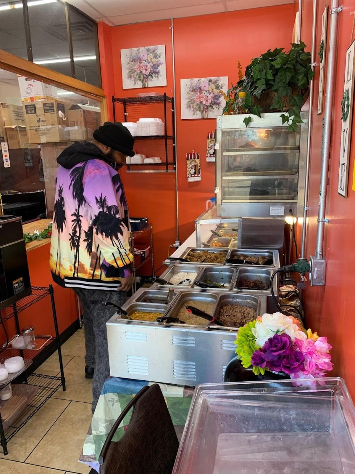 Zion Delight interior — customer at the self-serve cafeteria line, Atlanta soul food restaurant