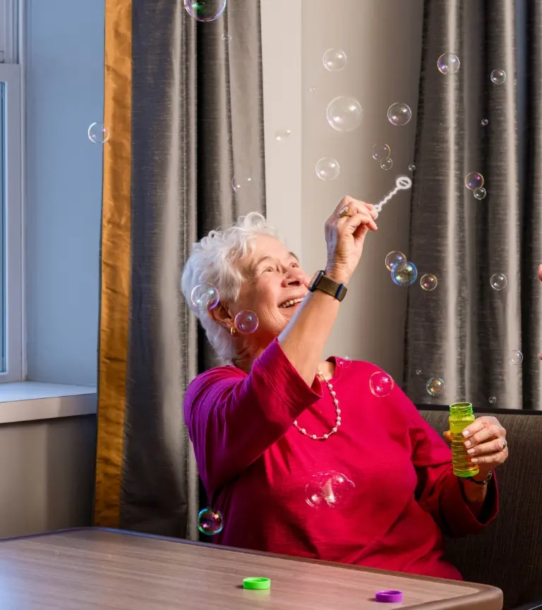 older woman mesmerized by bubbles