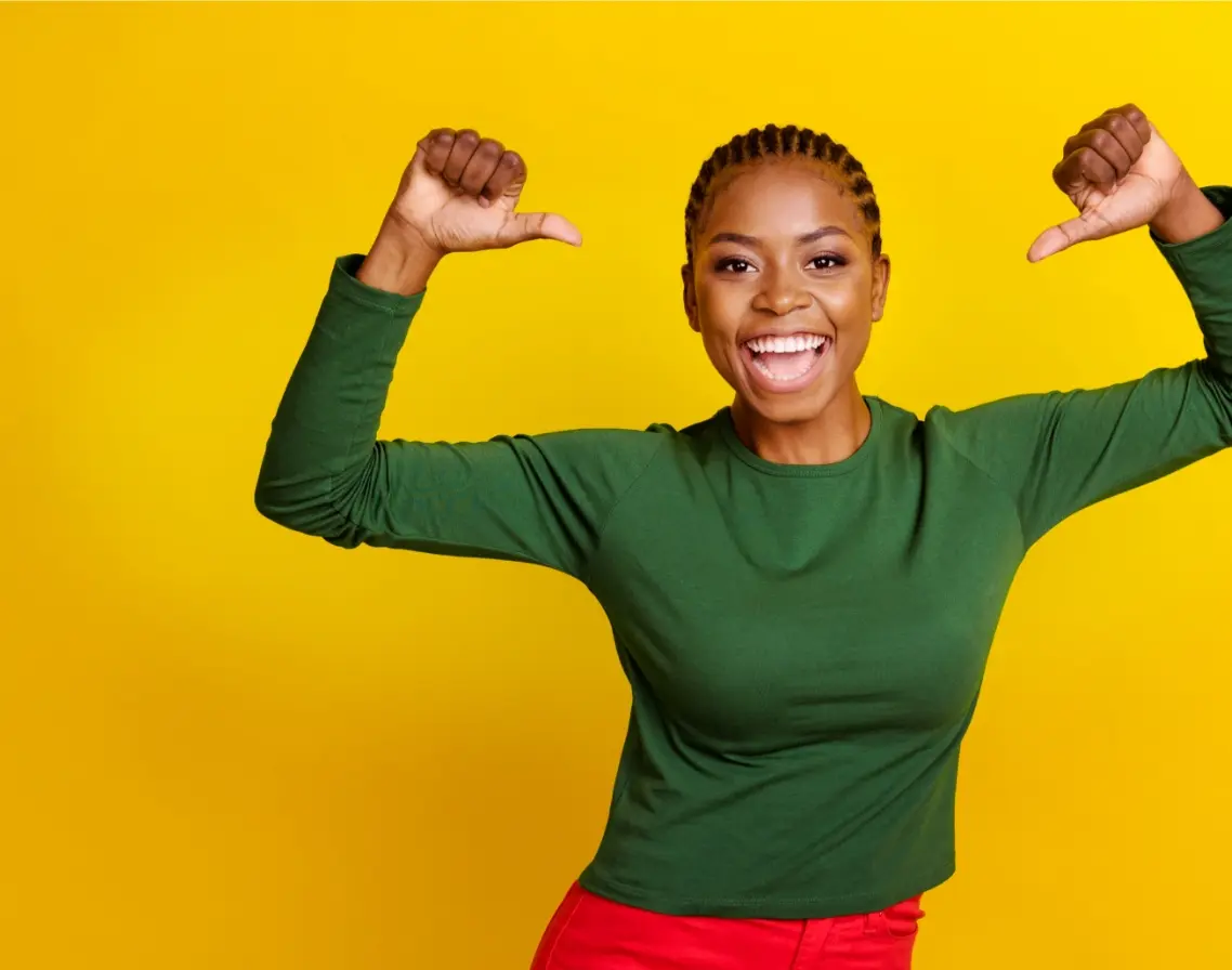 young woman directing thumbs proud of herself 