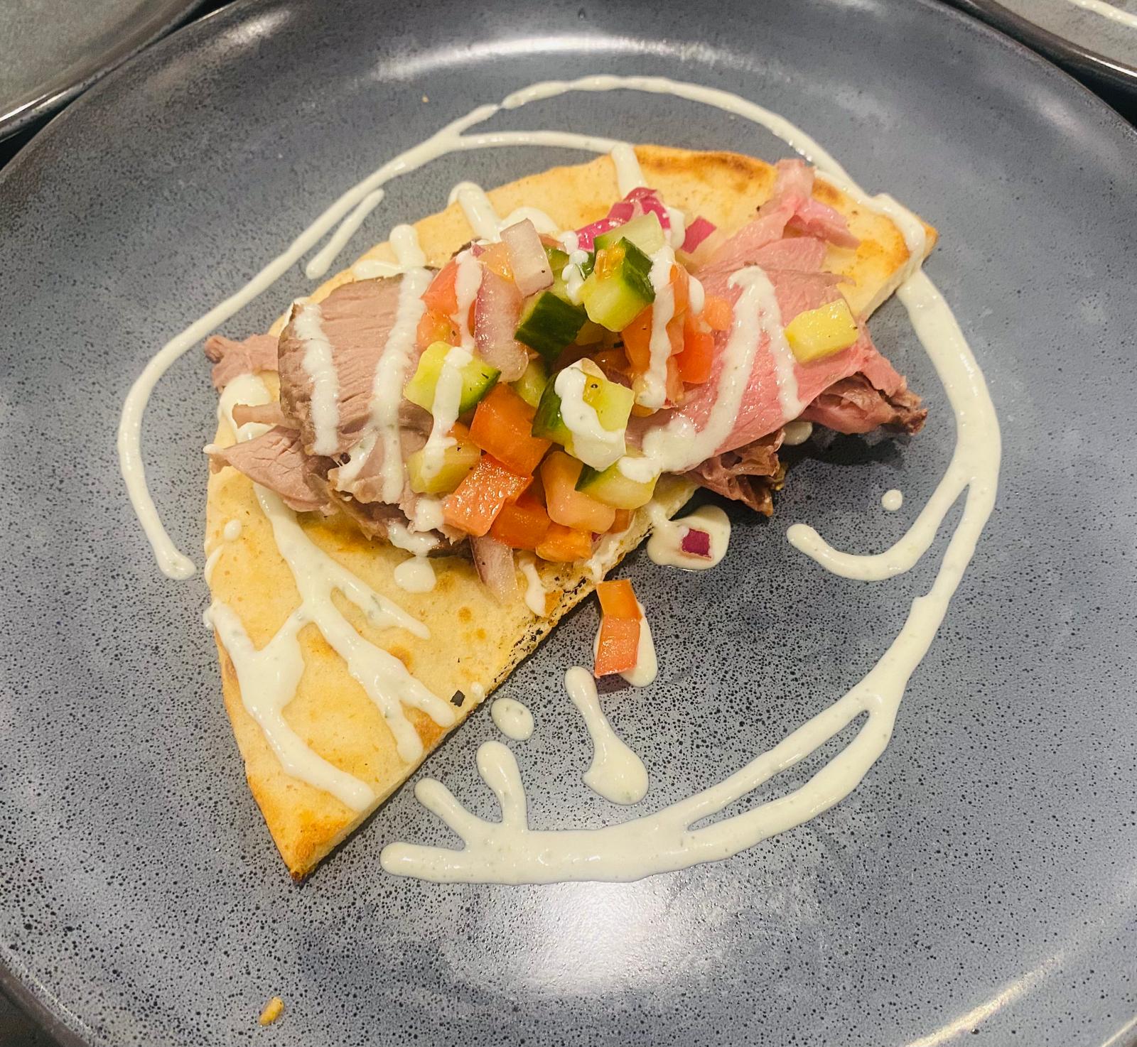 high end Mexican inspired dish with meats veggies and tortilla