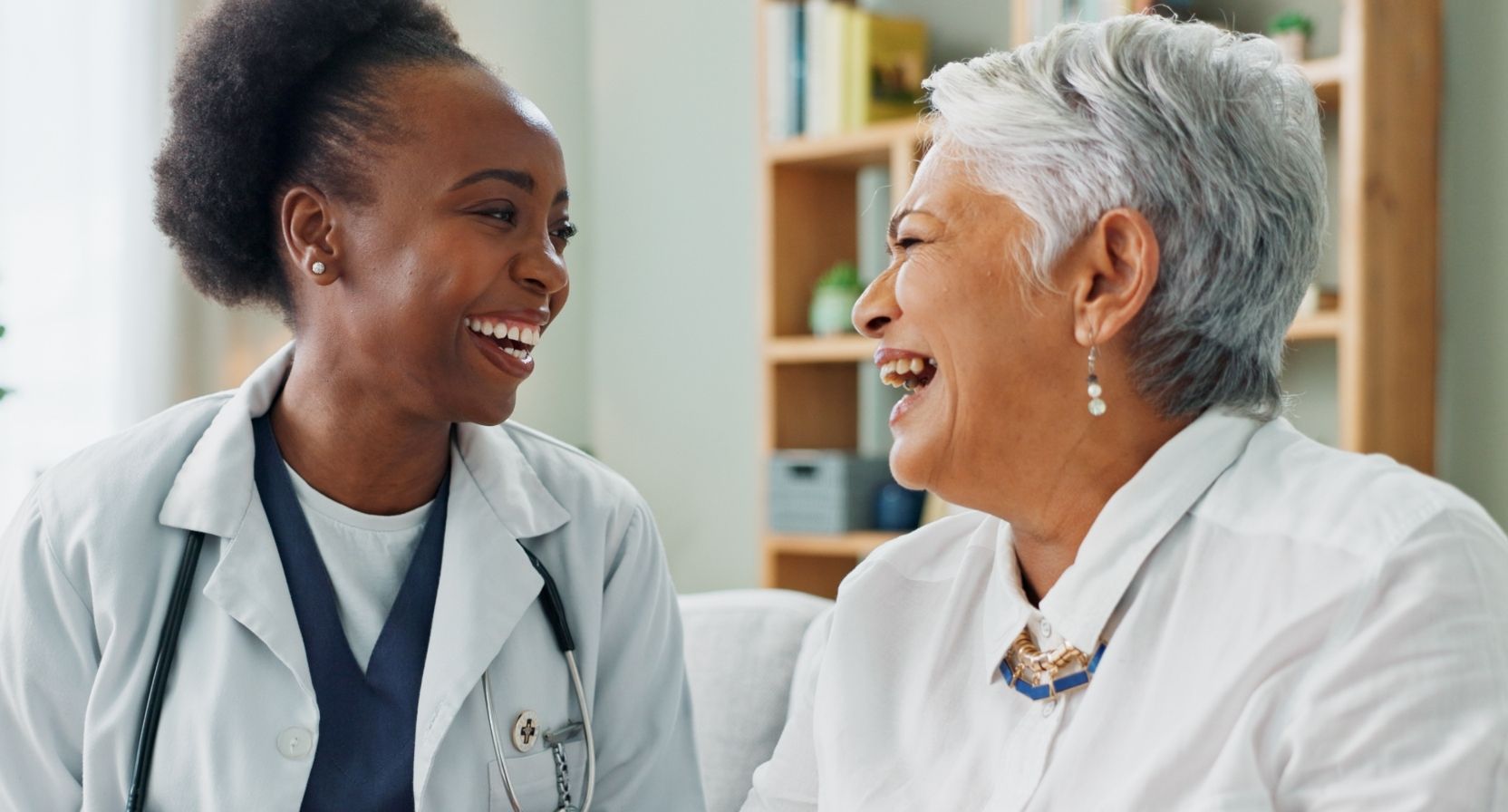 older woman laughing with doctor