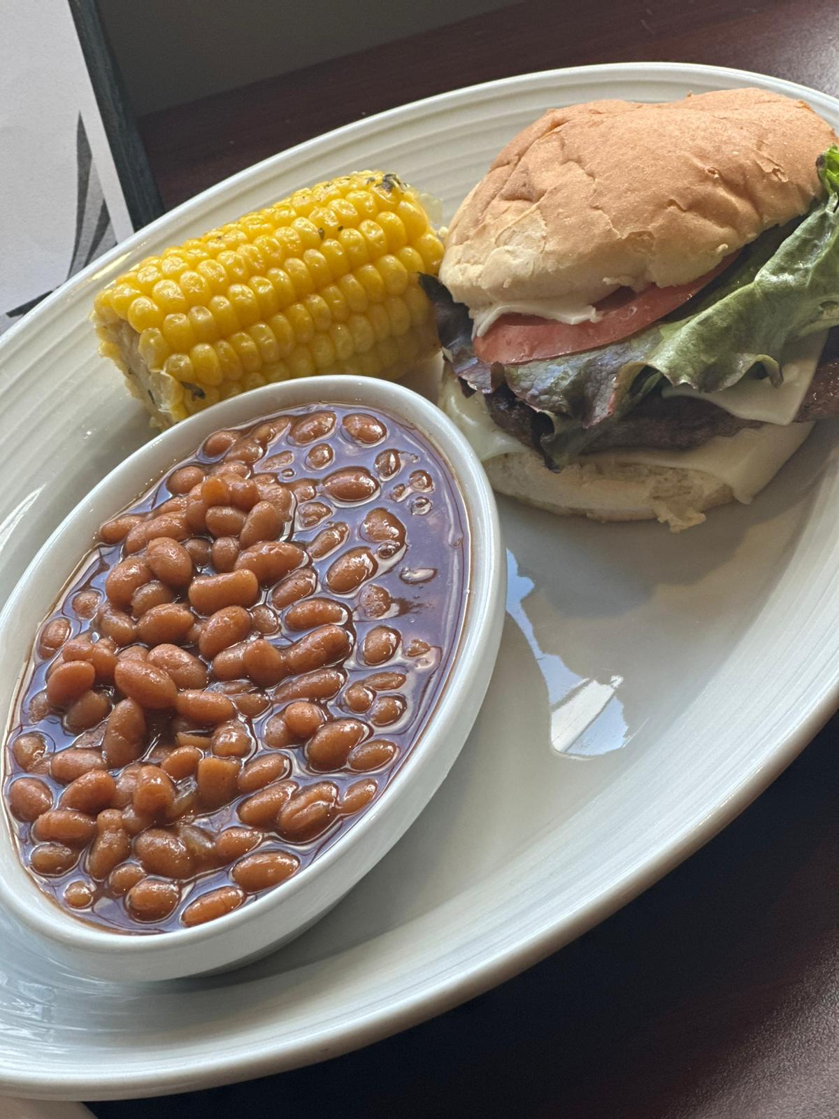 hamburger, beans, and corn on a plate