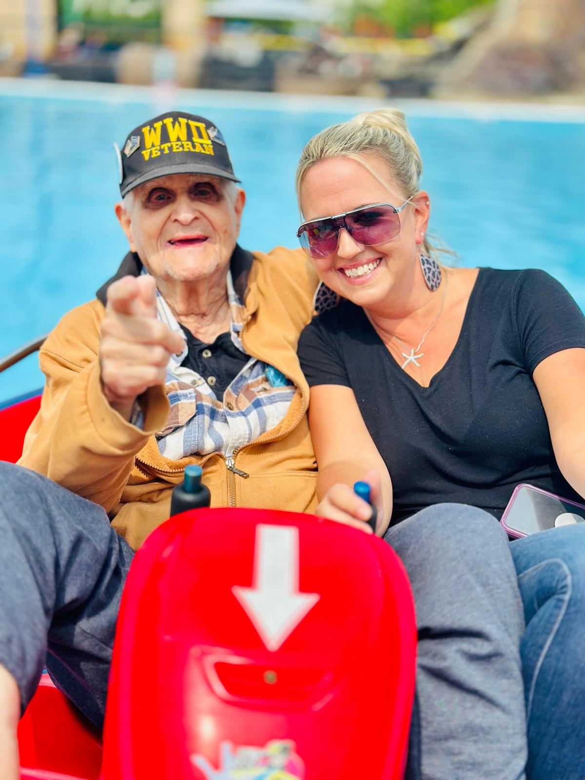 senior veteran on a carnival ride with smiling woman