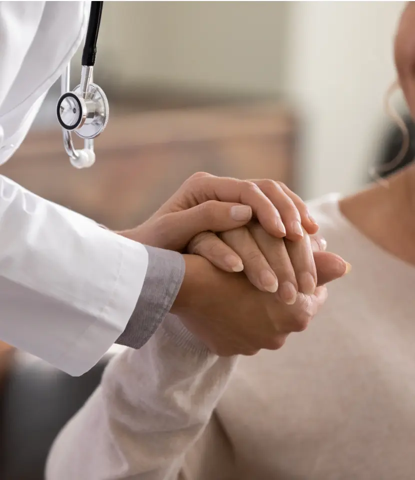 a medical professional holding hands with a patient