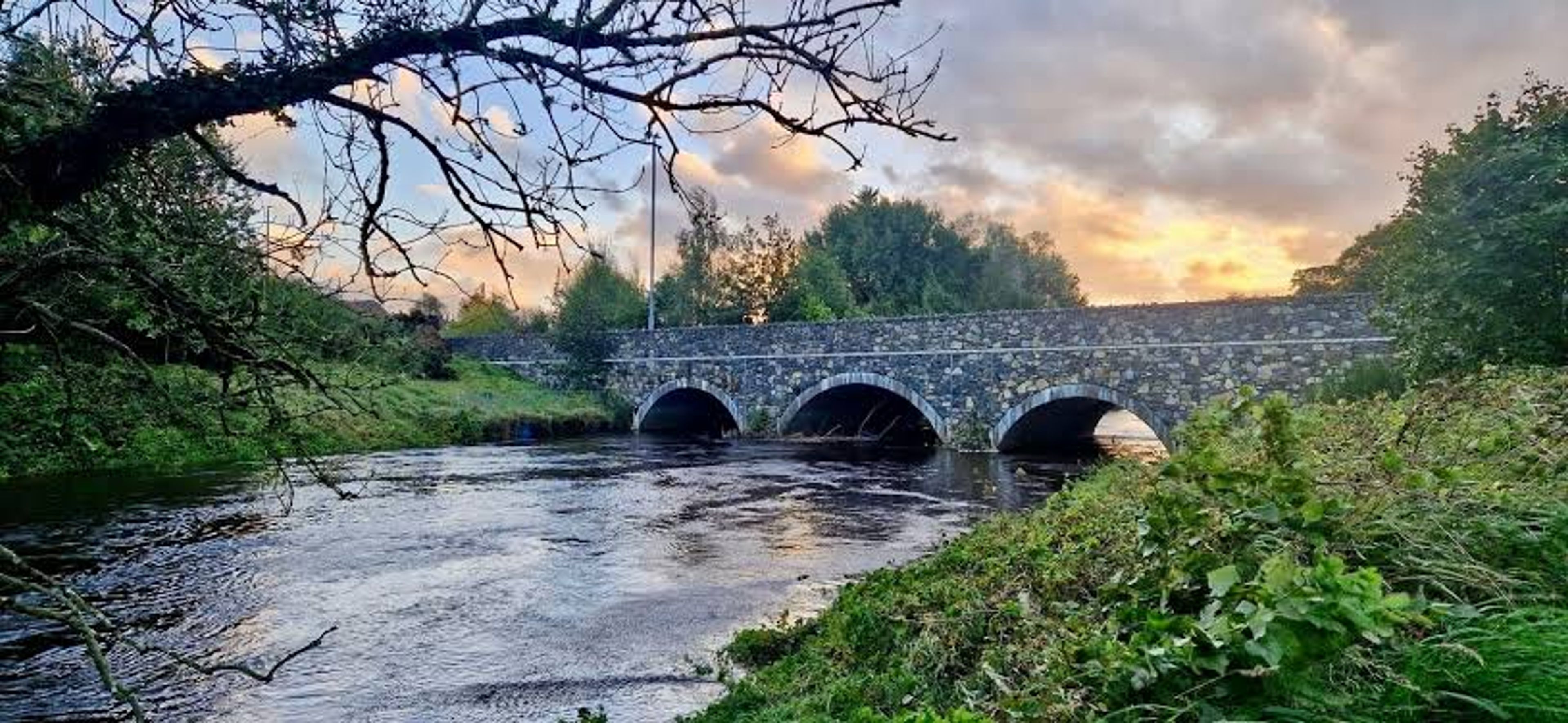 A stone arched bridge over a river near Ballymena, used as the header image for the Lowe Design web design in Ballymena page