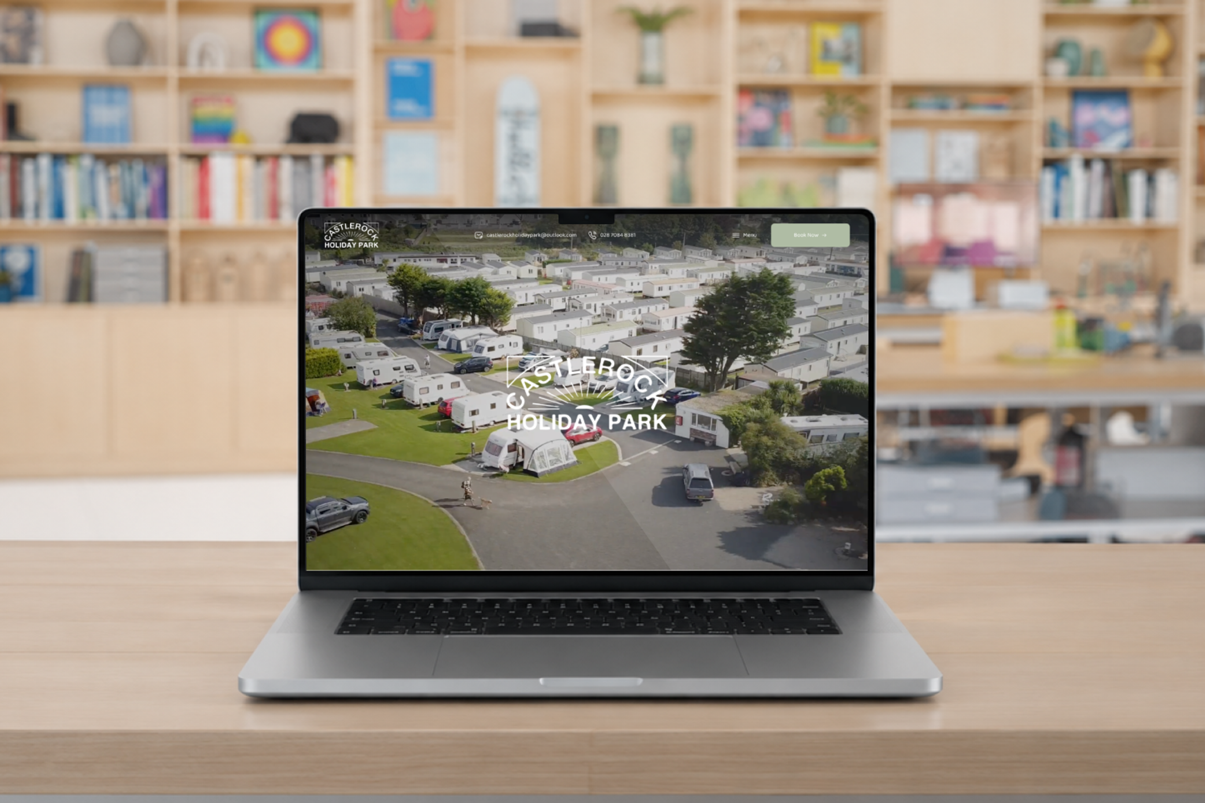 Castlerock Holiday Parks new website on a laptop in a design studio