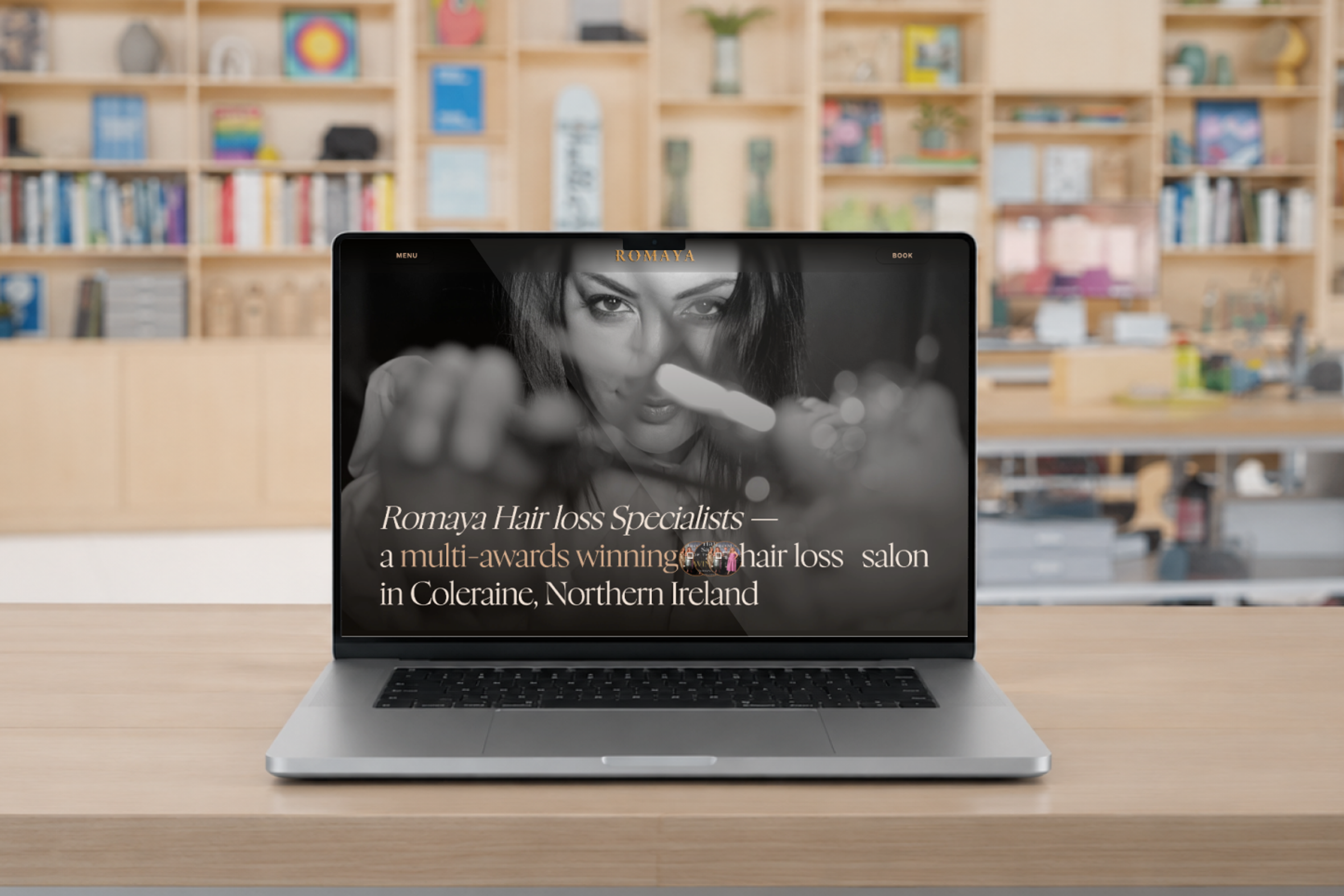 Romaya Hair Loss Specialists new website loaded on a MacBook Pro in a studio