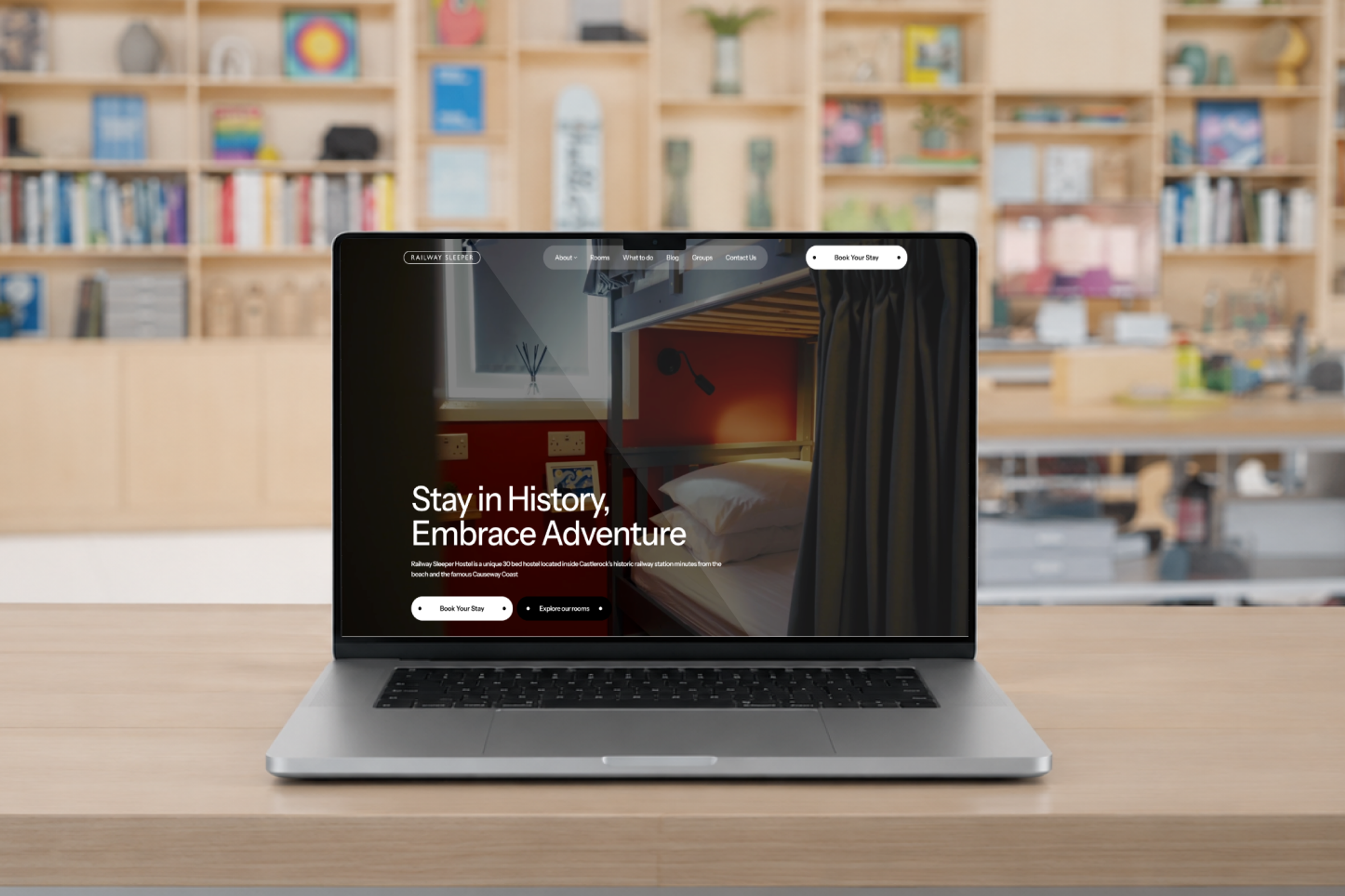 Railway Sleeper Hostel's new website displayed on a MacBook Pro in a design studio