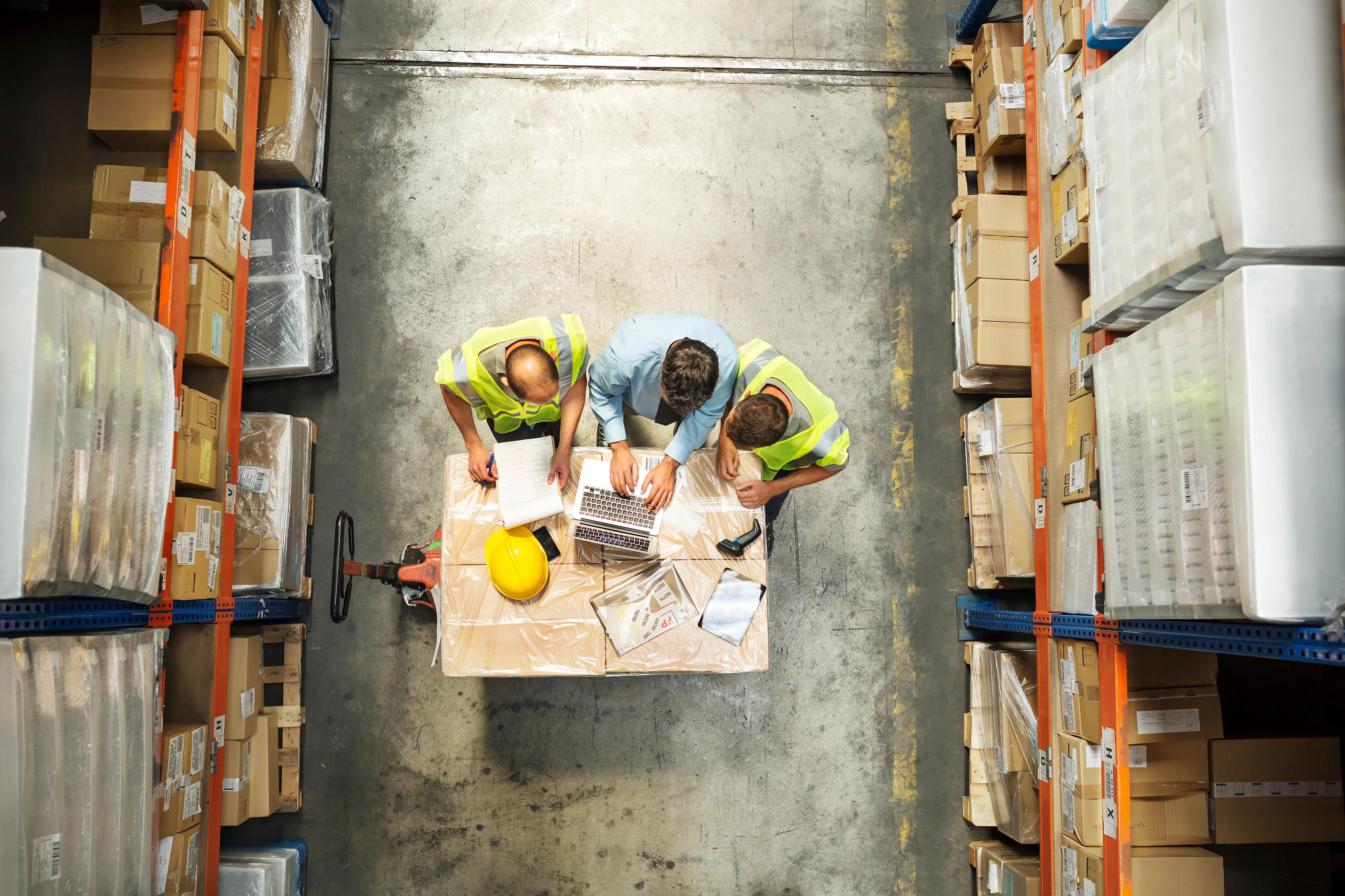 Warehouse workers managing inventory with supply chain integrations. 