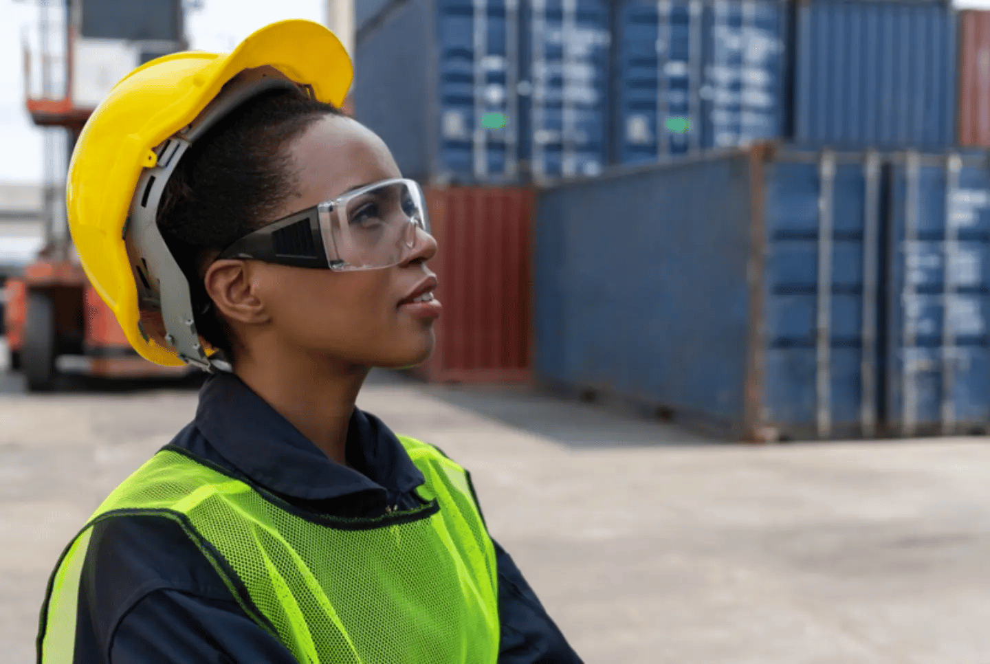 Supply chain professional standing in shipyard with hardhat and goggles. Women comprise 41% of the supply chain workforce in 2021.