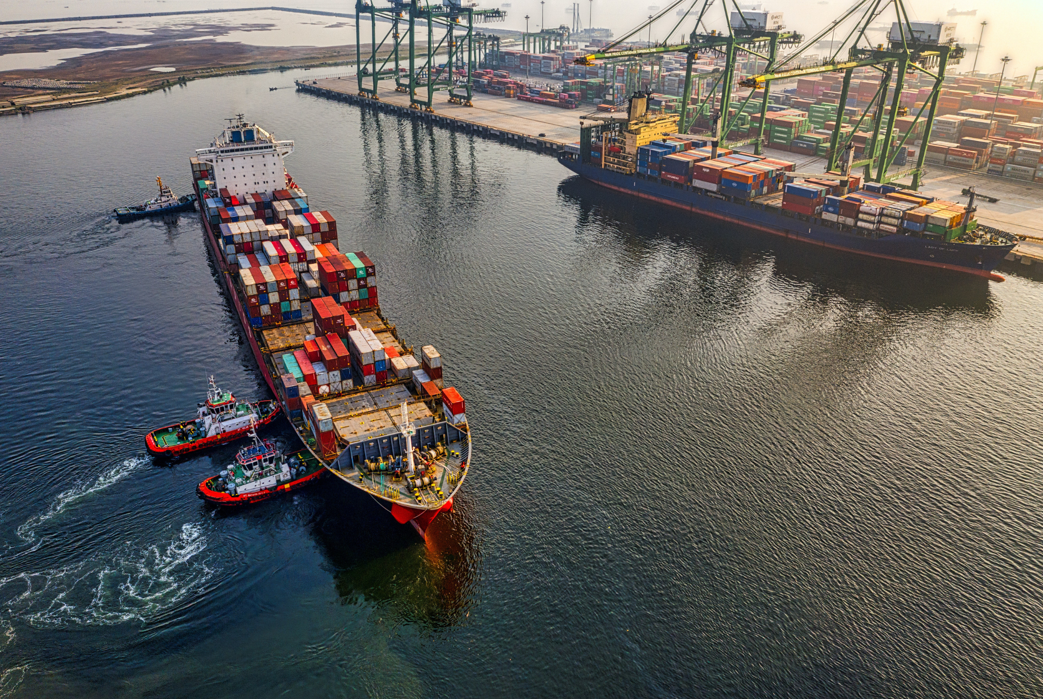 Cargo ship and containers being tracked by supply chain visibility software