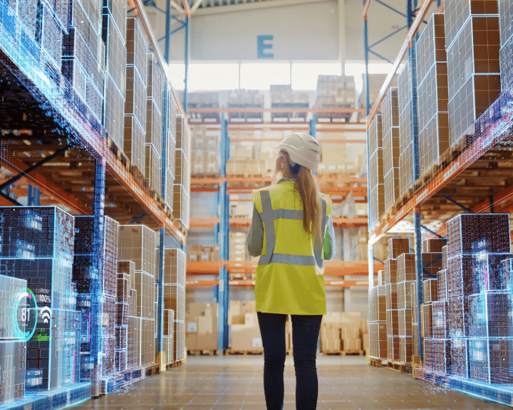 woman in warehouse learning that chain.io can help supply chain and logistics companies with bookings/confirmations, ISF details, milestones, ASNs, documents, invoices) plus send Purchase Orders & item master data sets from a shipper to a Logistics Service Provider.