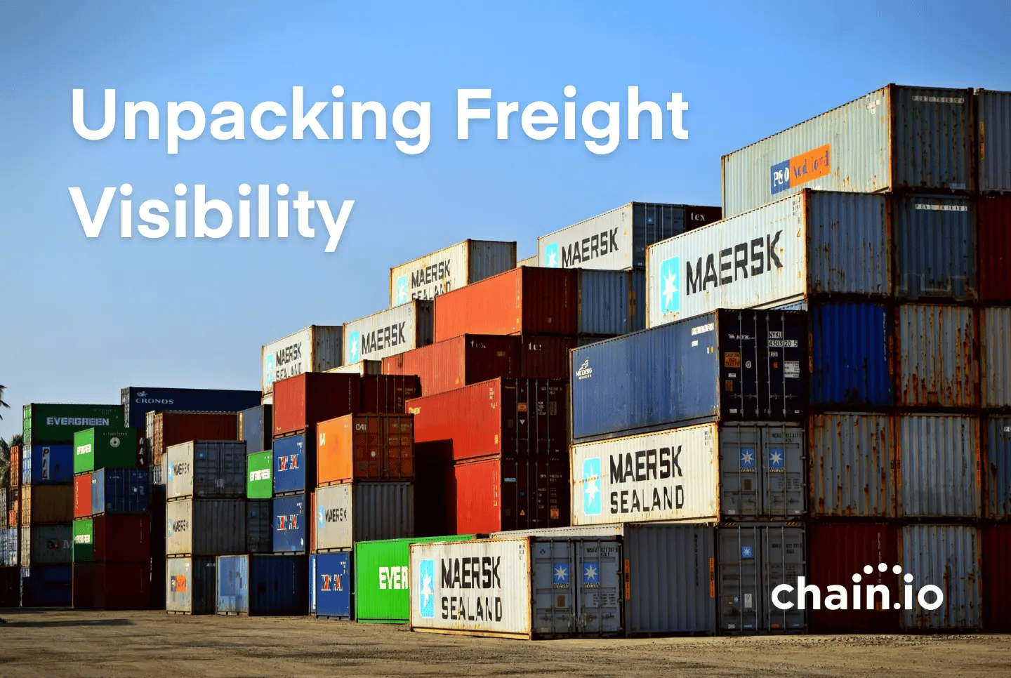 Shipping containers stacked in foreground under the text "unpacking freight visibility"
