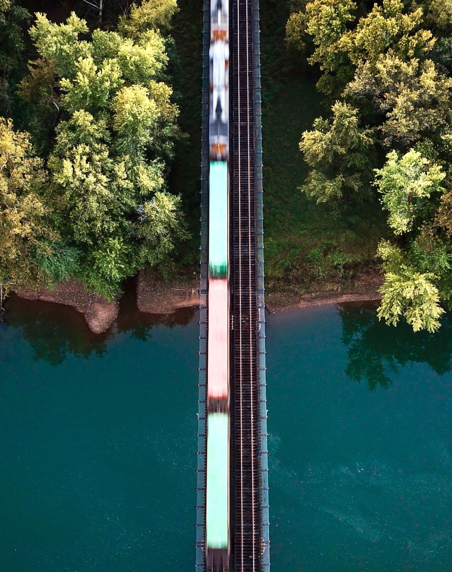 Train traveling over water and land. 