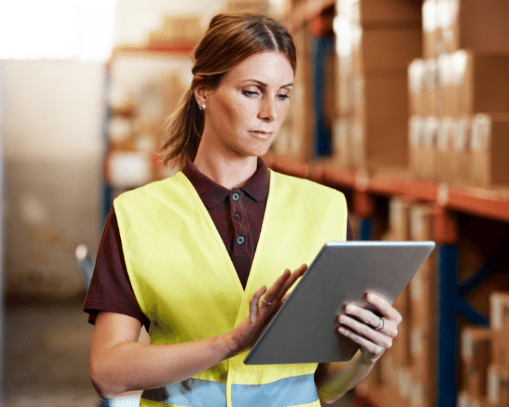 woman in warehouse sends ASNs & Milestones from a Logistics Service Provider to a Shipper