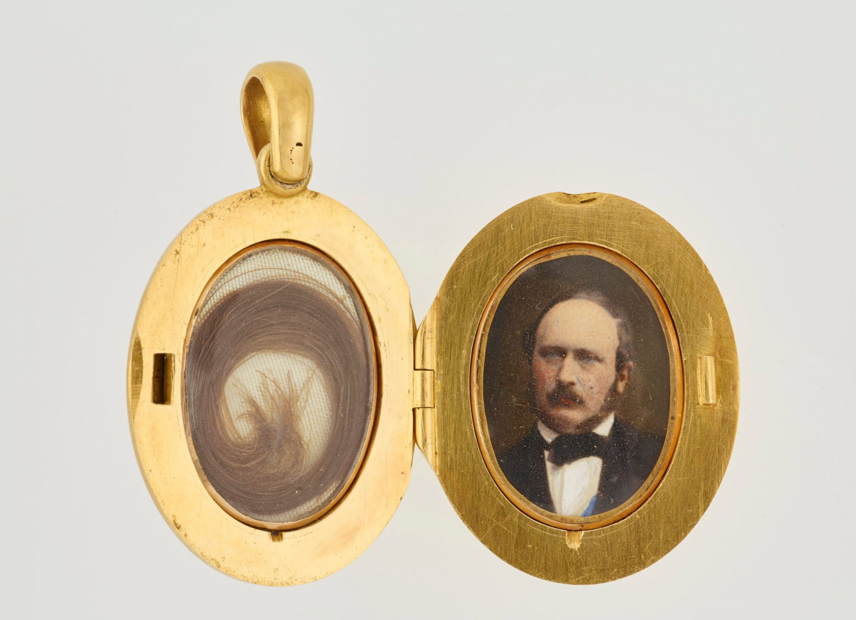 The locket opens to reveal hair on one side and photograph of Prince Albert on the other, both under glass, in the Royal Collection Trust