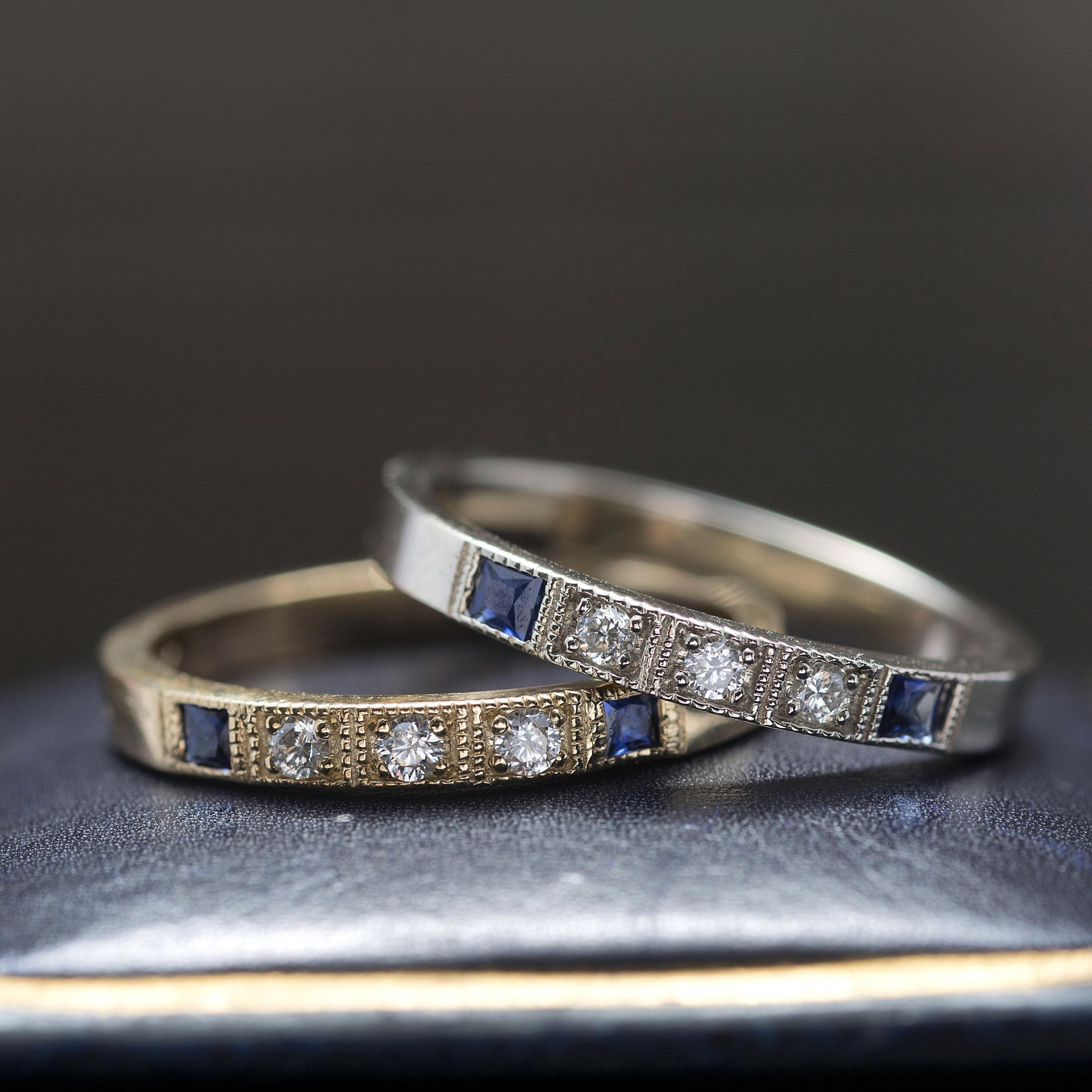 Detail of two Esther Rings, one white gold with sapphires, one yellow gold with sapphires