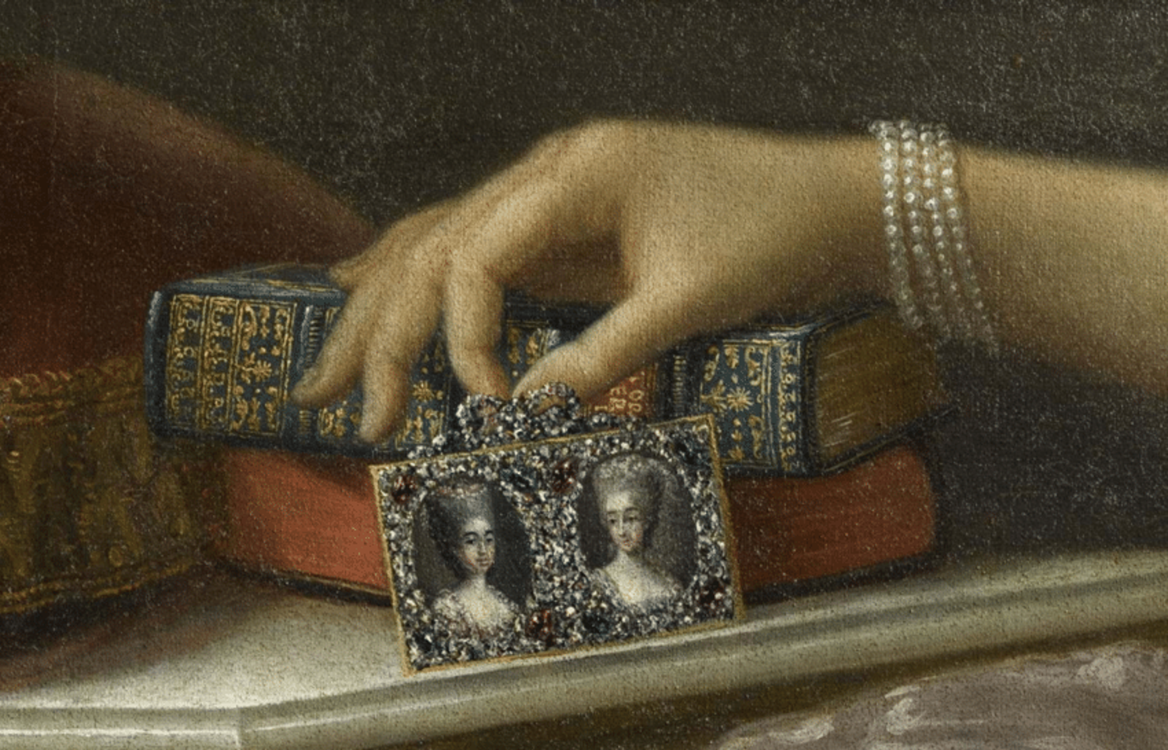 What looks to be a cut steel picture frame in a detail from Portrait of Maria Antonia of Spain holding two portraits of her daughters by Anton Raphael Mengs, after 1773. Palace of Versailles.