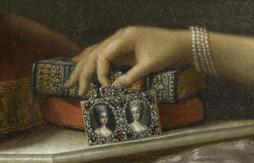 What looks to be a cut steel picture frame in a detail from Portrait of Maria Antonia of Spain holding two portraits of her daughters by Anton Raphael Mengs, after 1773. Palace of Versailles. 