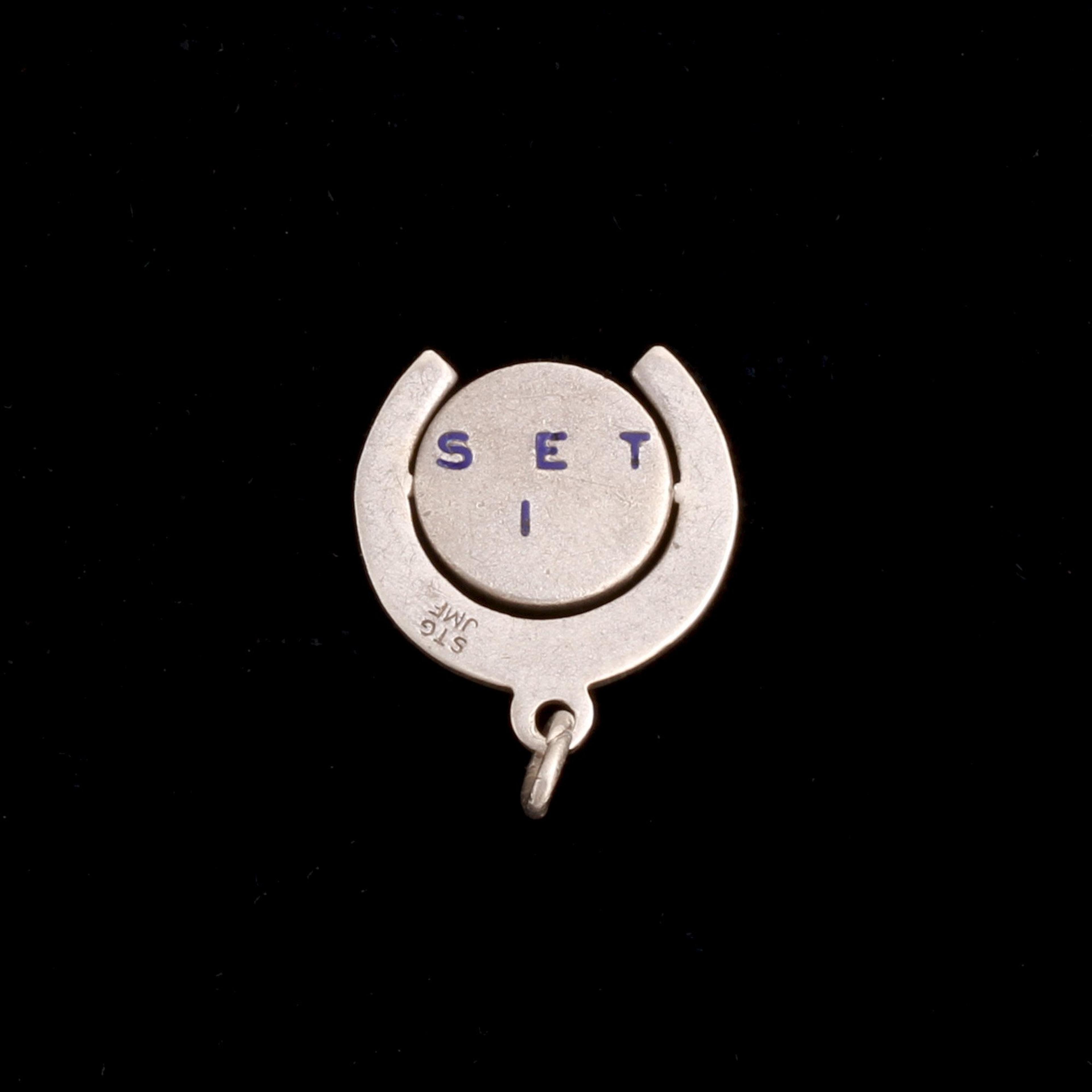 detail of 1920s "Sweet Sixteen" Horseshoe Spinner Charm