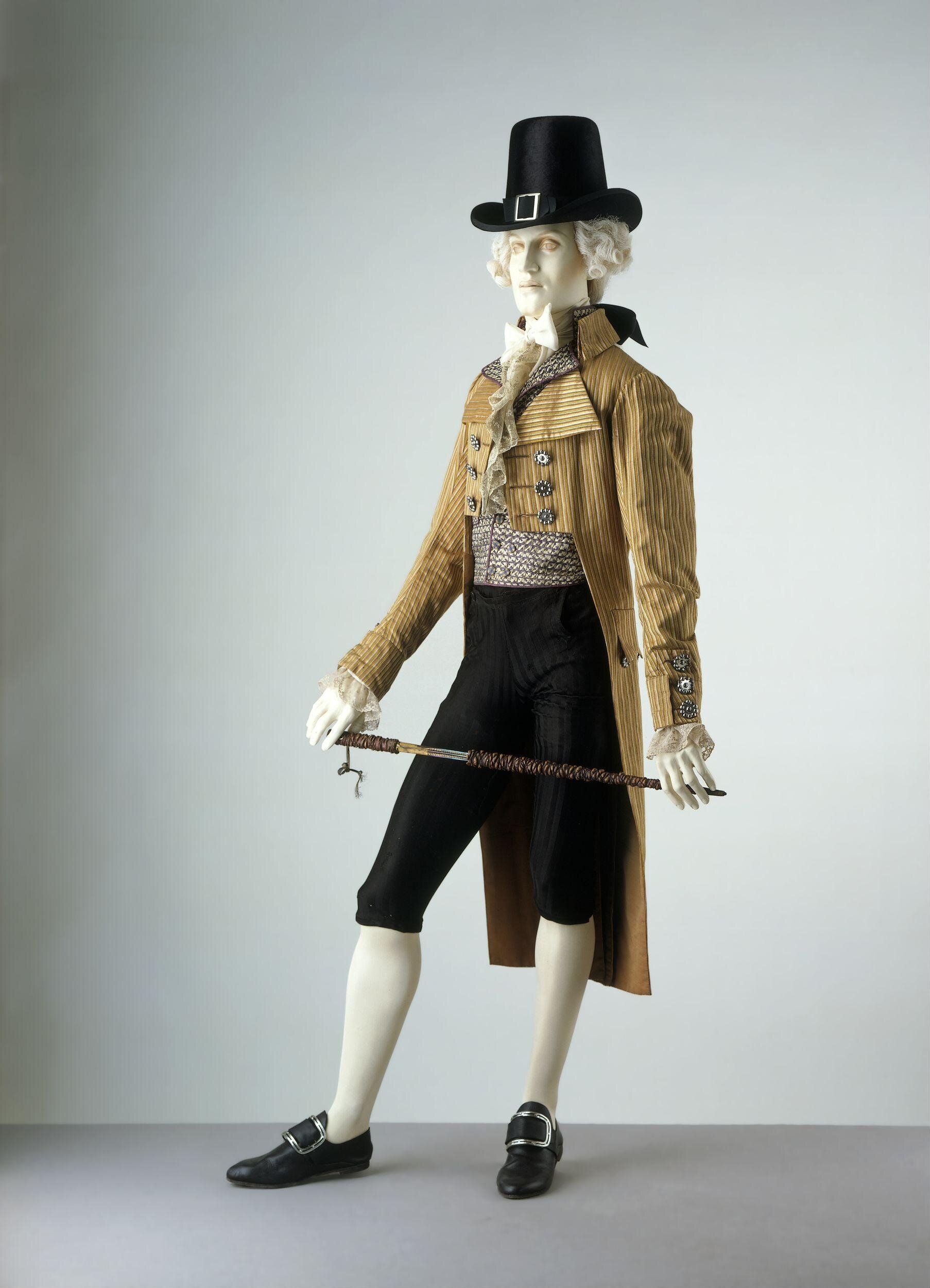 Cut steel was the perfect compliment to the exaggerated style fashionable in the late 1790s. Note the large lapel. Cut steel became popular for shoe buckles and buttons in the 1750s. It was a fraction of the price of paste. Coat, 1795-1805. The Victoria & Albert Museum.   