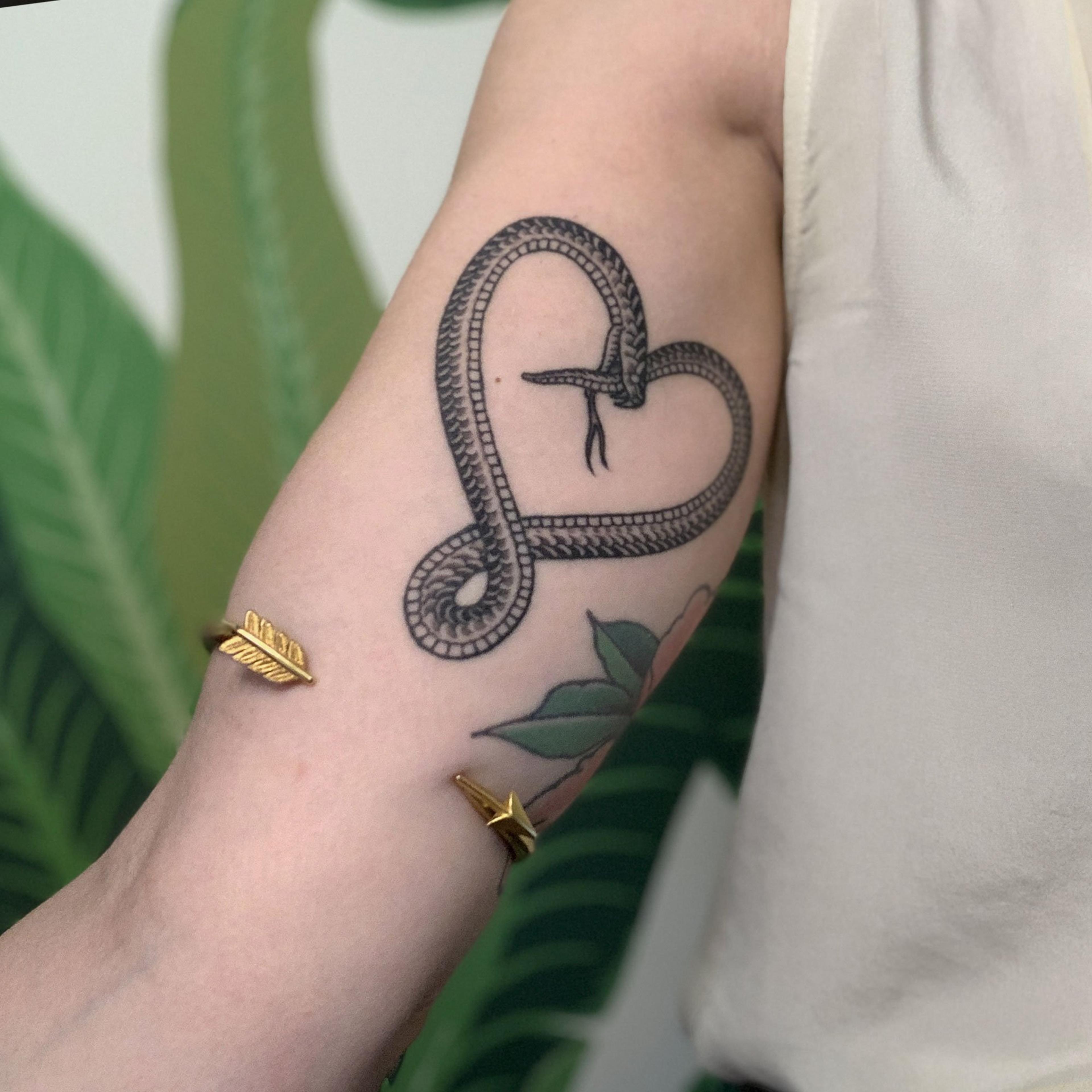 Closeup of someone wearing the 1920s Golden Arrow Upper Arm Bracelet