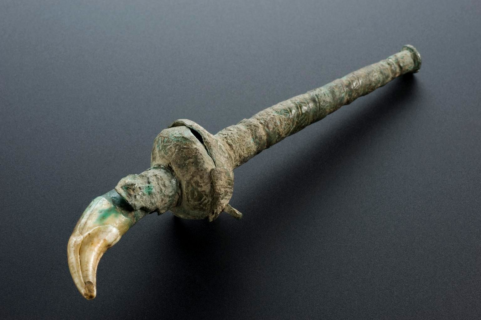 Roman teething charm set in bronze handle. To get its full amuletic benefit, the tooth should be placed on the body, but never touch the floor. Science Museum Group. 