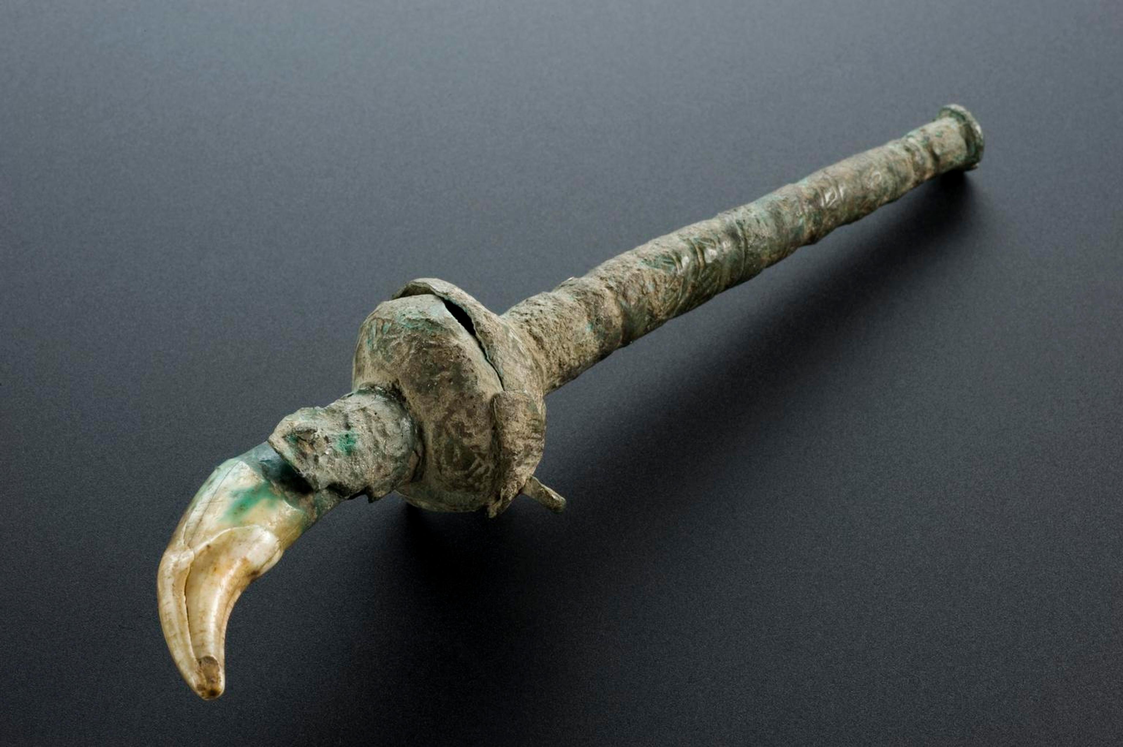 Roman teething charm set in bronze handle. To get its full amuletic benefit, the tooth should be placed on the body, but never touch the floor. Science Museum Group.