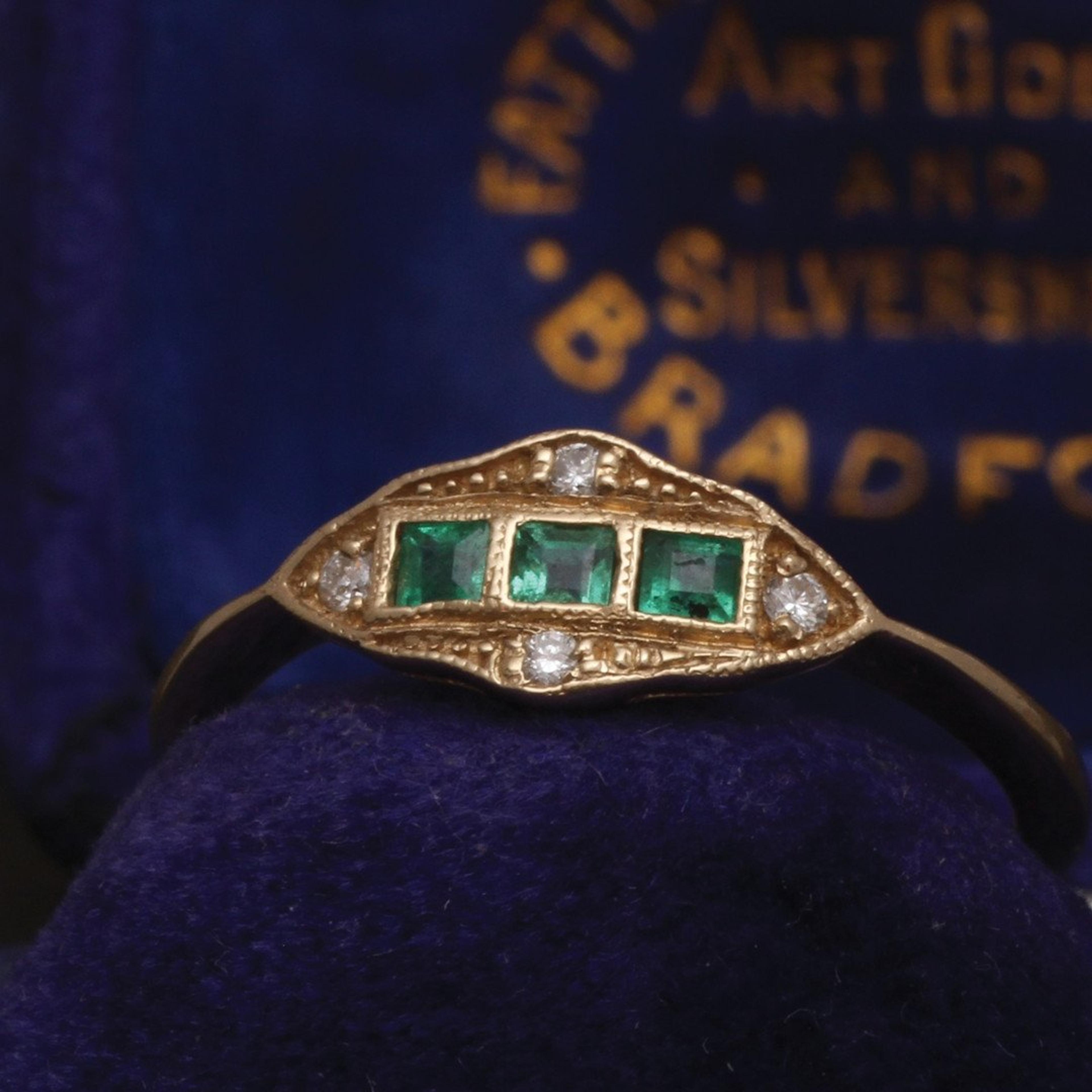 Closeup of the Machine Age Ring with three emeralds