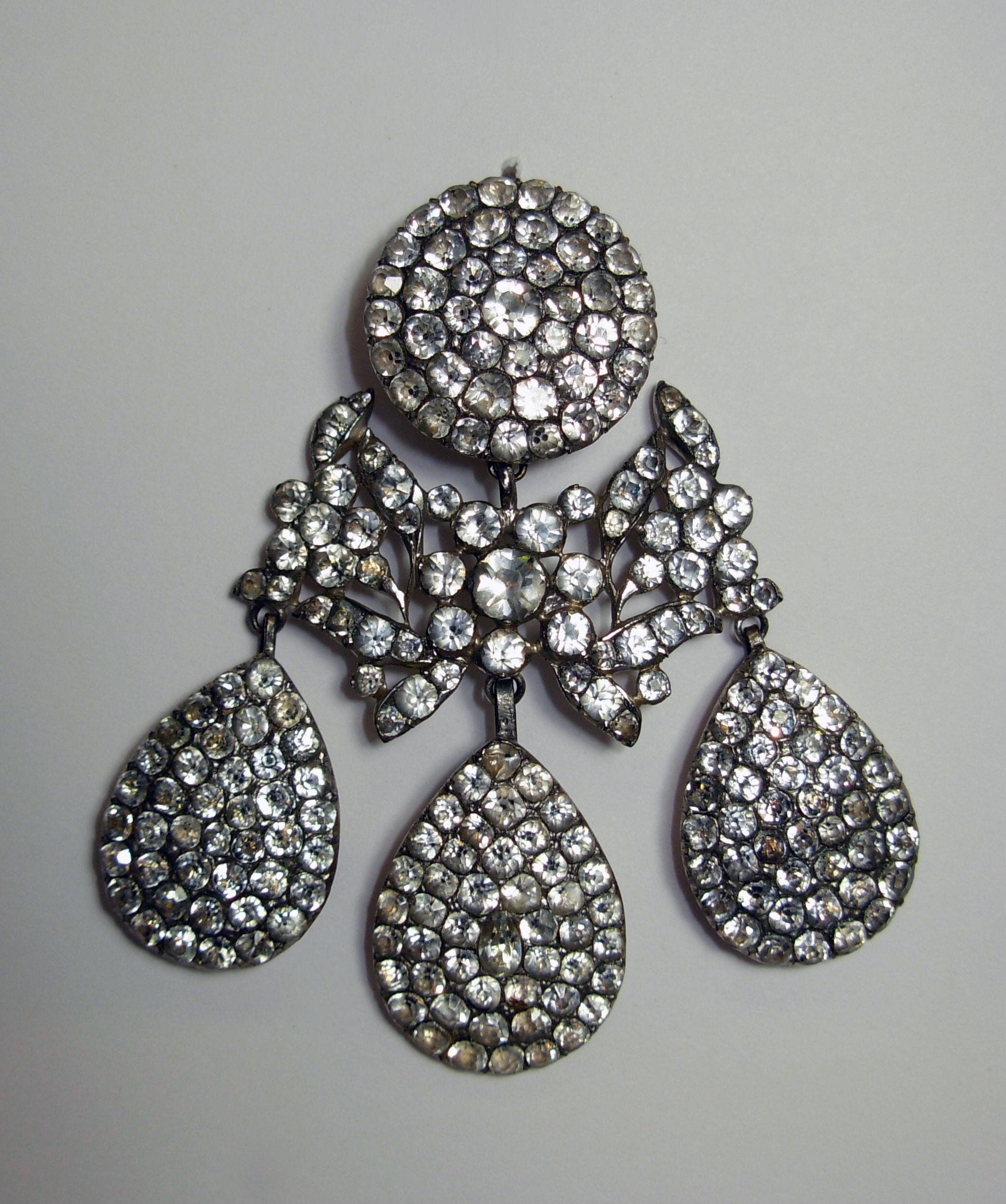 Paste girandole earrings, 1800-1860. Each paste is in a closed setting with a black spot painted on the cullet of each.
