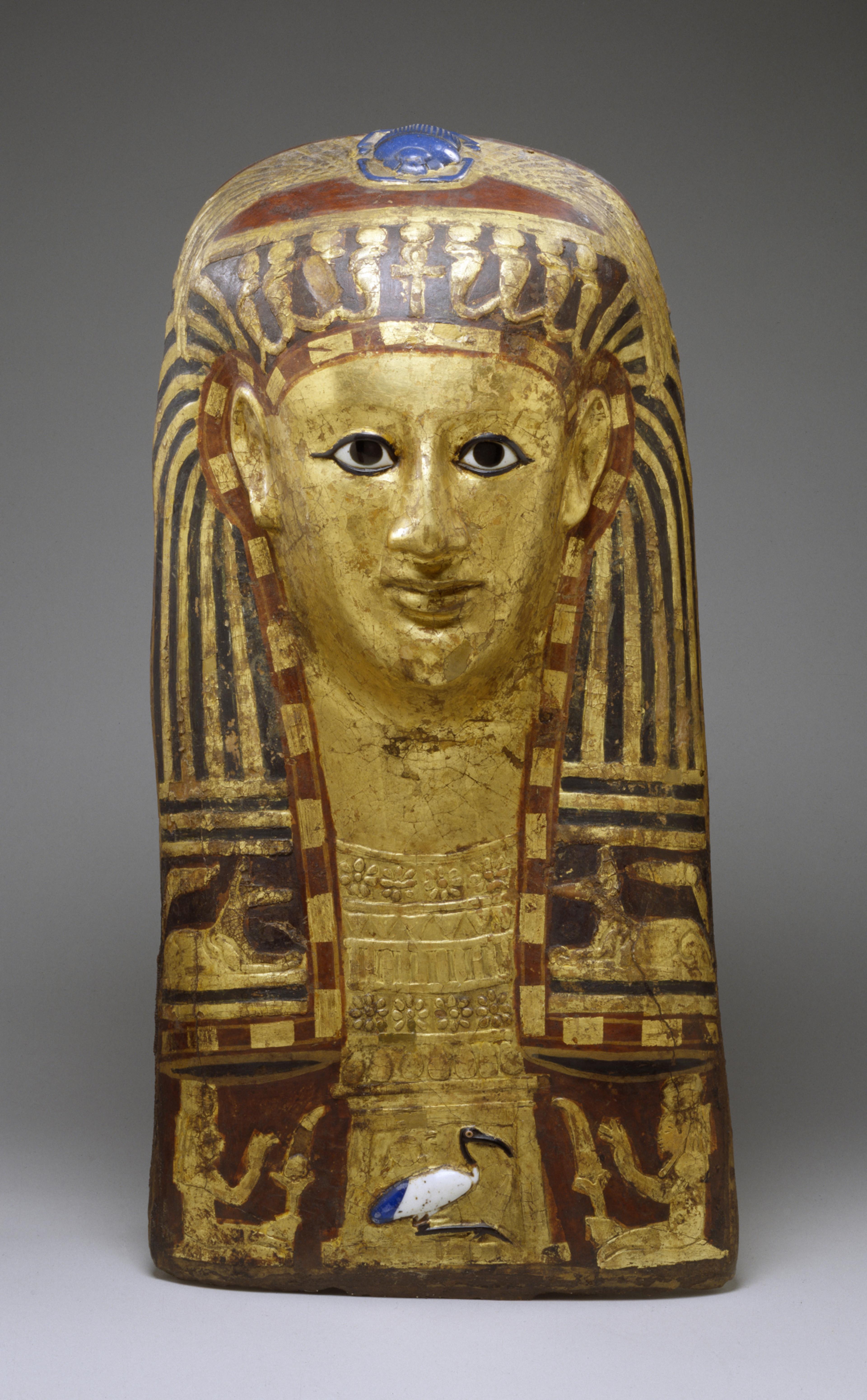 An Egyptian funerary mask with a blue glass scarab - a symbol of renewal - on the top of the head. Cartonnage Mask of a Woman, mid 1st century BCE - mid 1st century CE. The Walters Art Museum.
