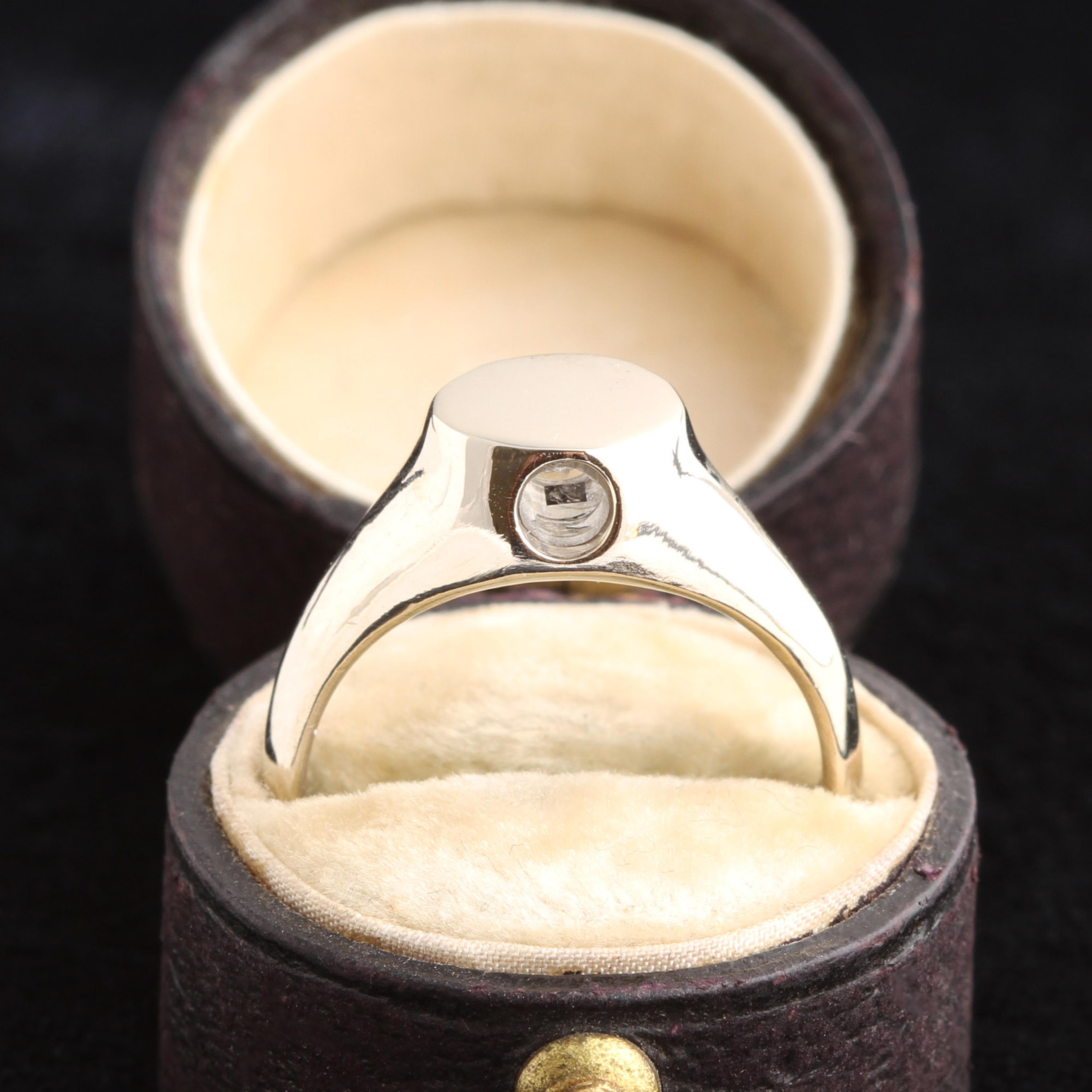 Photo of the white gold peep show ring in an antique box.